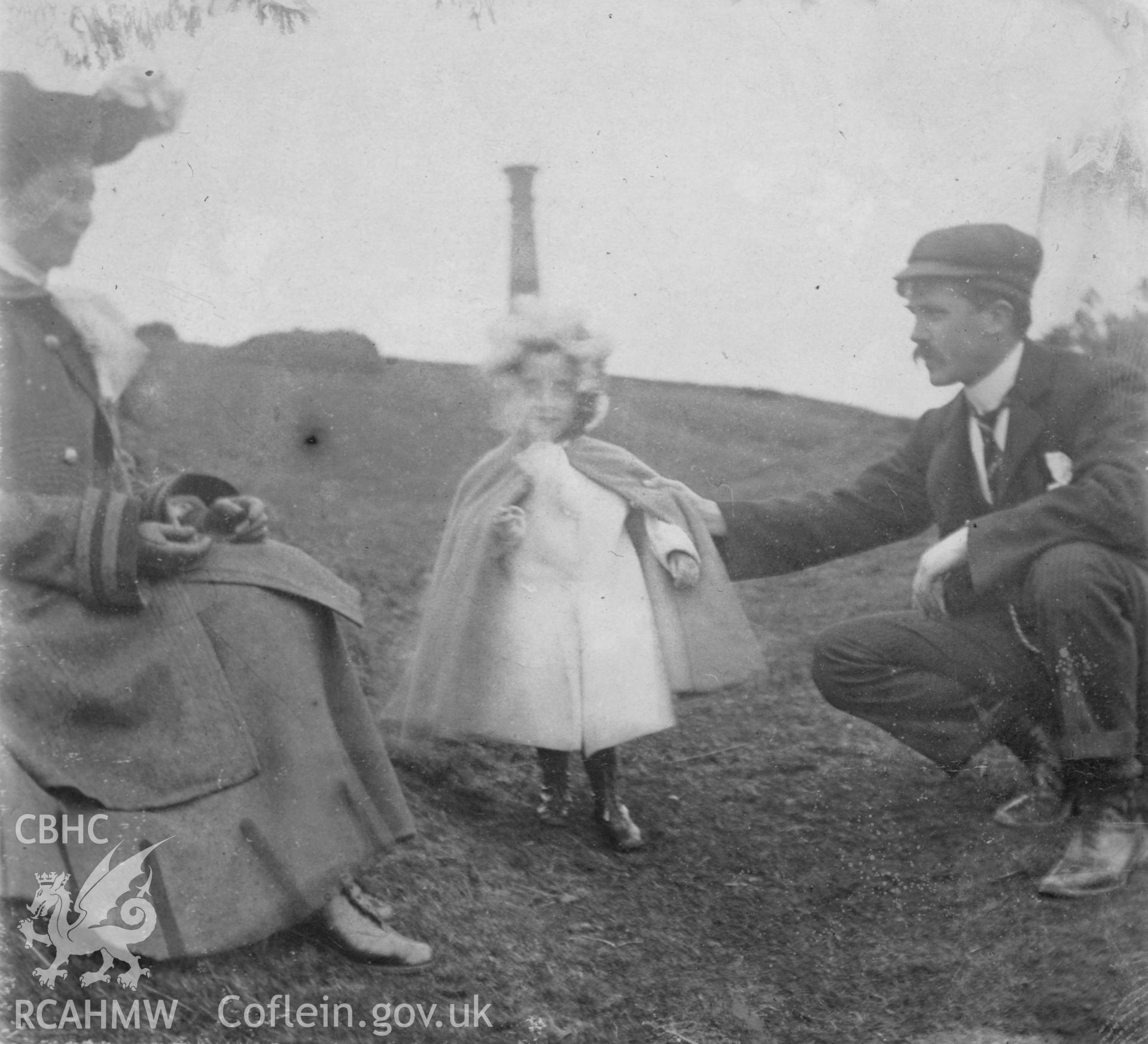 "1904". Photo of two adults and a child on Pen Dinas. Digitised from a photograph album showing views of Aberystwyth and District, produced by David John Saer, school teacher of Aberystwyth. Loaned for copying by Dr Alan Chamberlain.