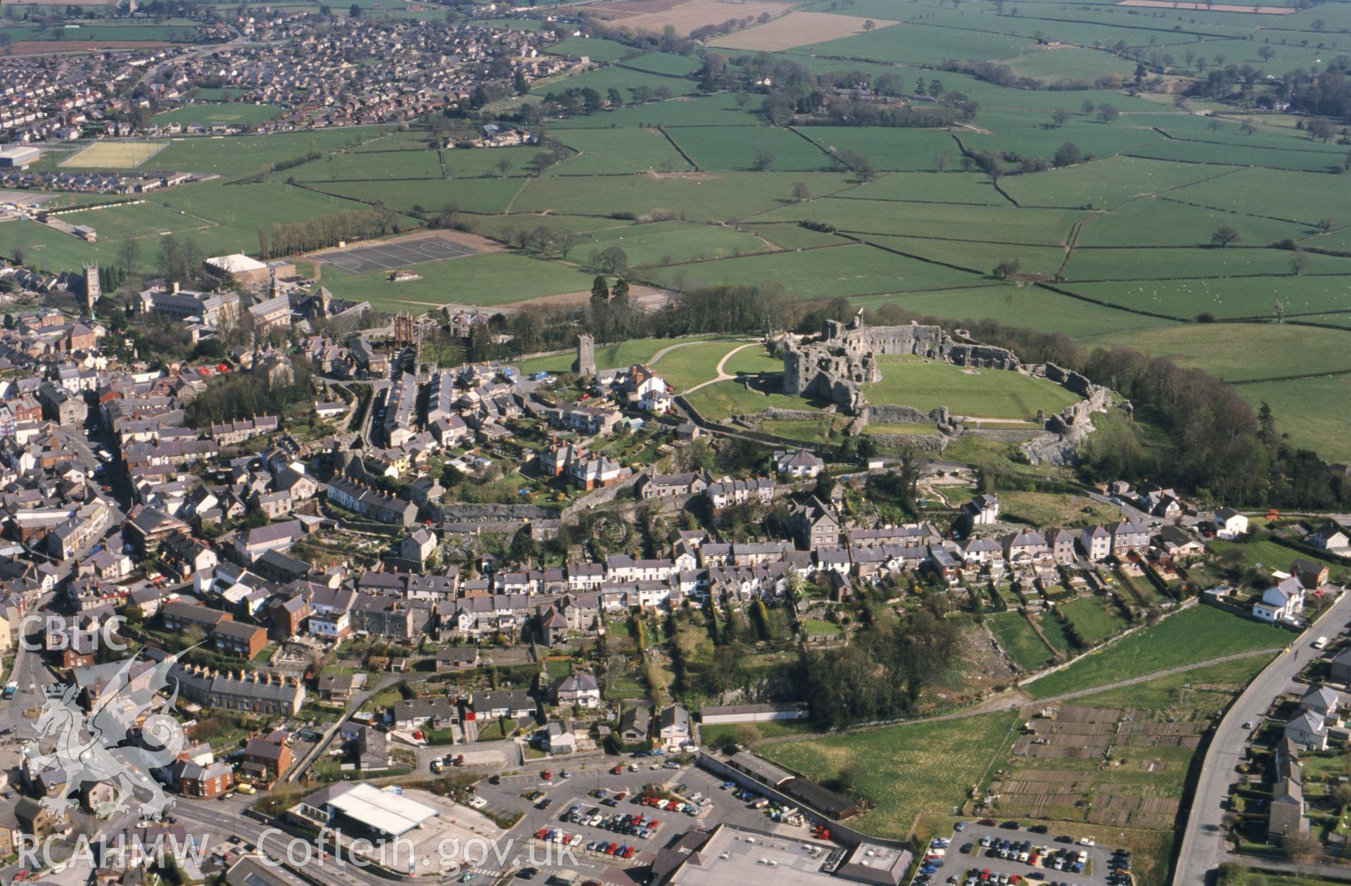 RCAHMW colour oblique aerial photograph of Denbigh, townscape with castle, from northwest. Taken by Toby Driver on 08/04/2003