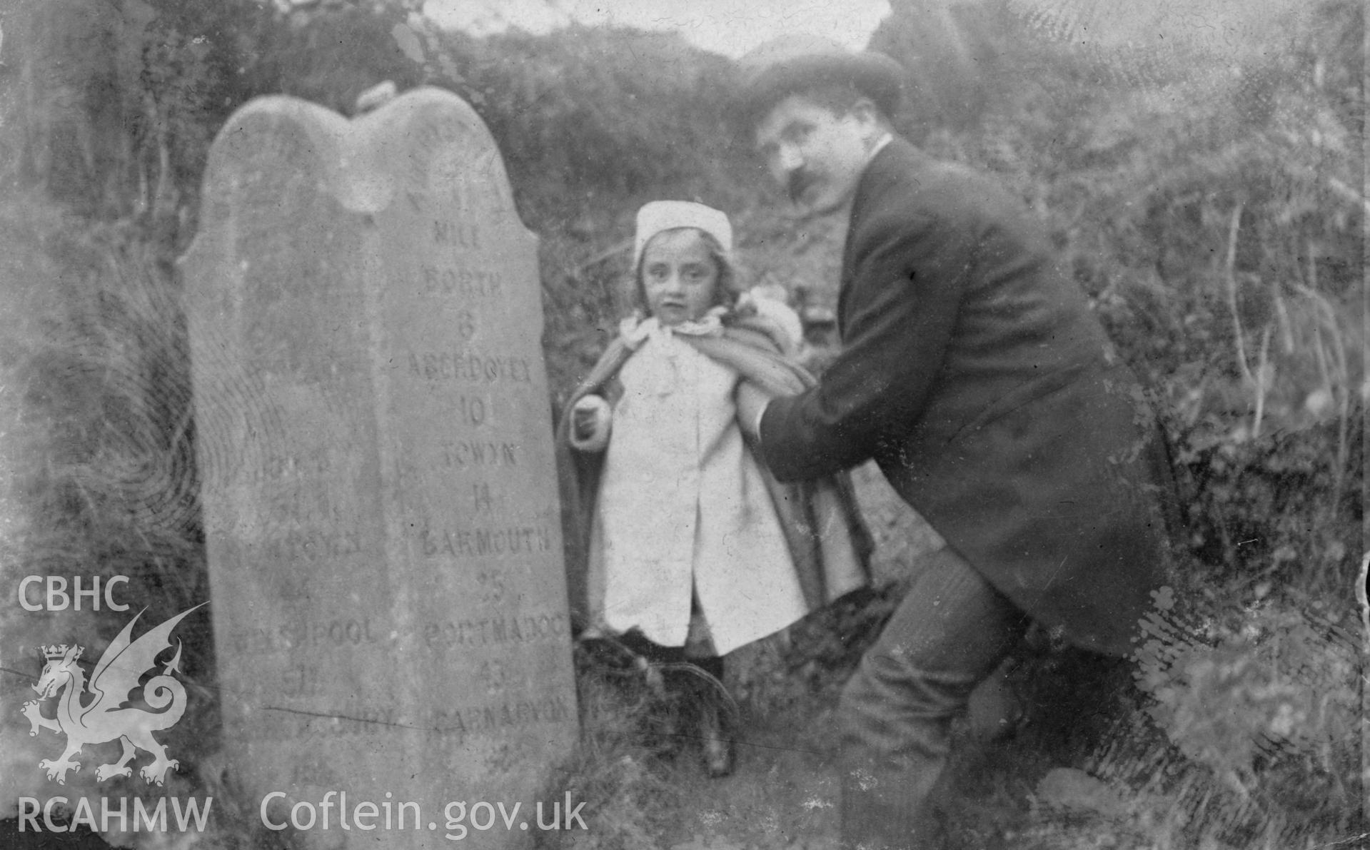 "1904". Photo of an adult and child standing by a milestone. Digitised from a photograph album showing views of Aberystwyth and District, produced by David John Saer, school teacher of Aberystwyth. Loaned for copying by Dr Alan Chamberlain.