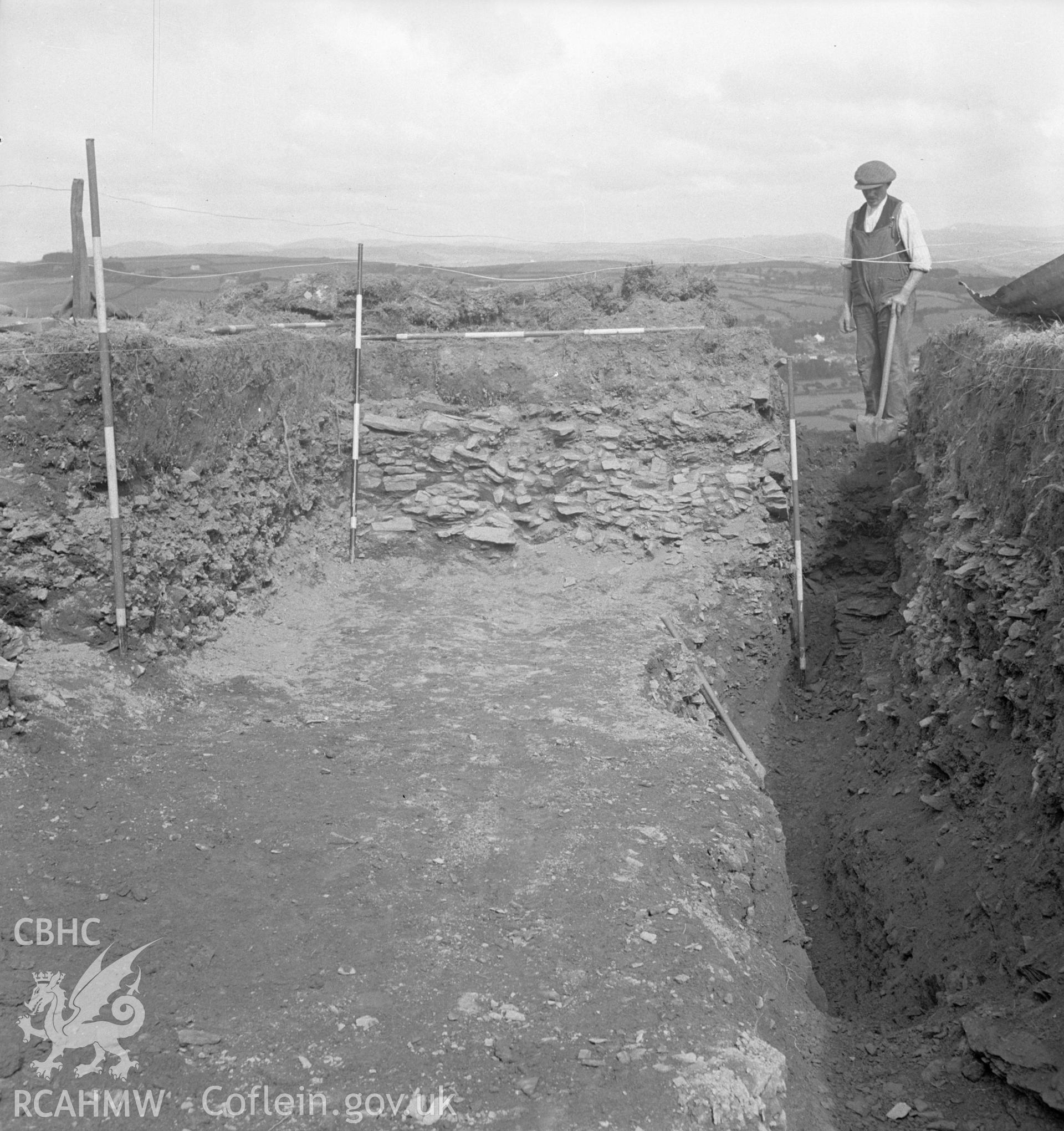 Excavation detail showing member of excavation team at work