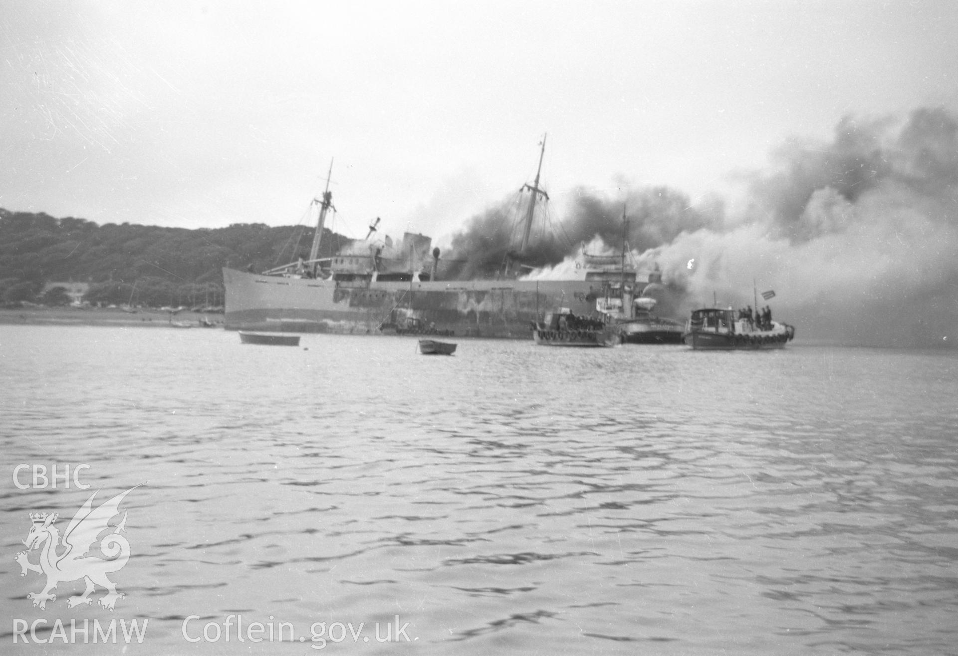 View showing SS Etrog in flames, taken from the shore at Dale.