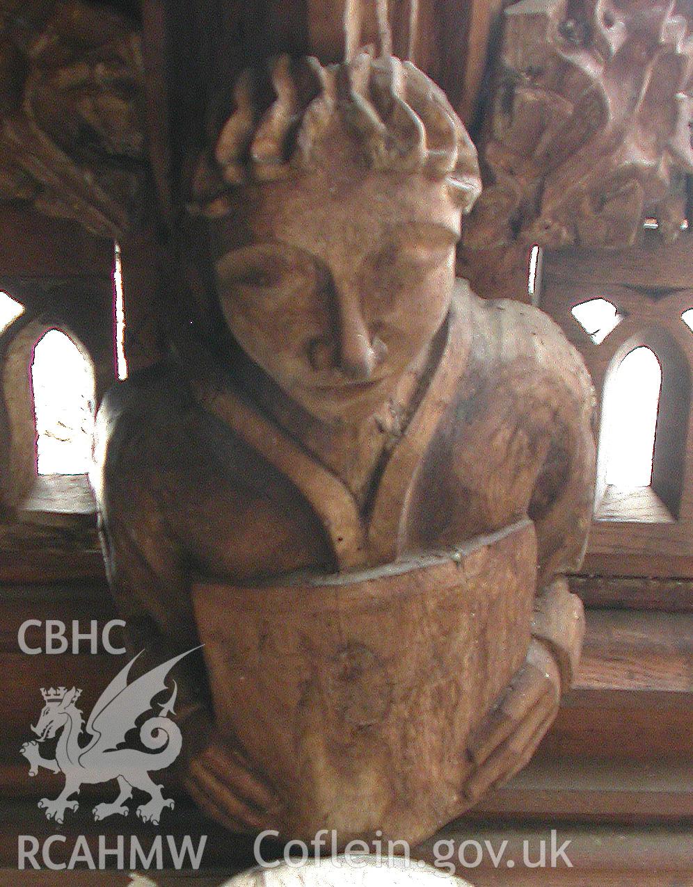 Carved wooden head between Trusses II & III, North side.