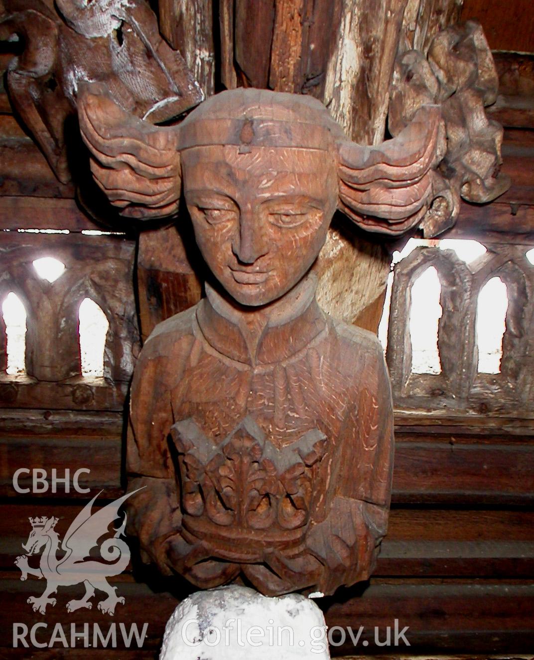 Carved wooden head between Trusses I & II, South side.