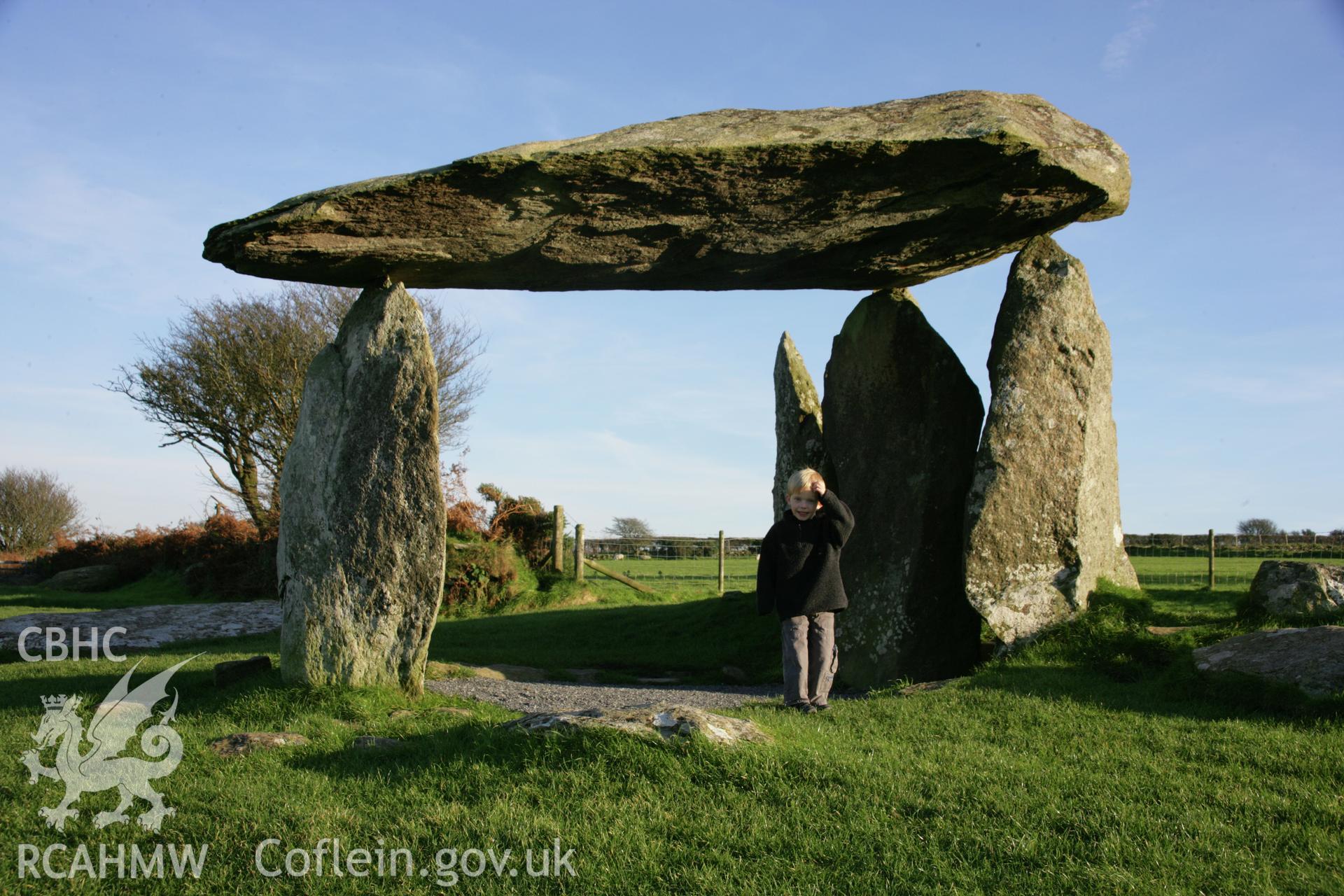 Pentre Ifan chambered tomb at sunset; view of the chamber from the west with child.