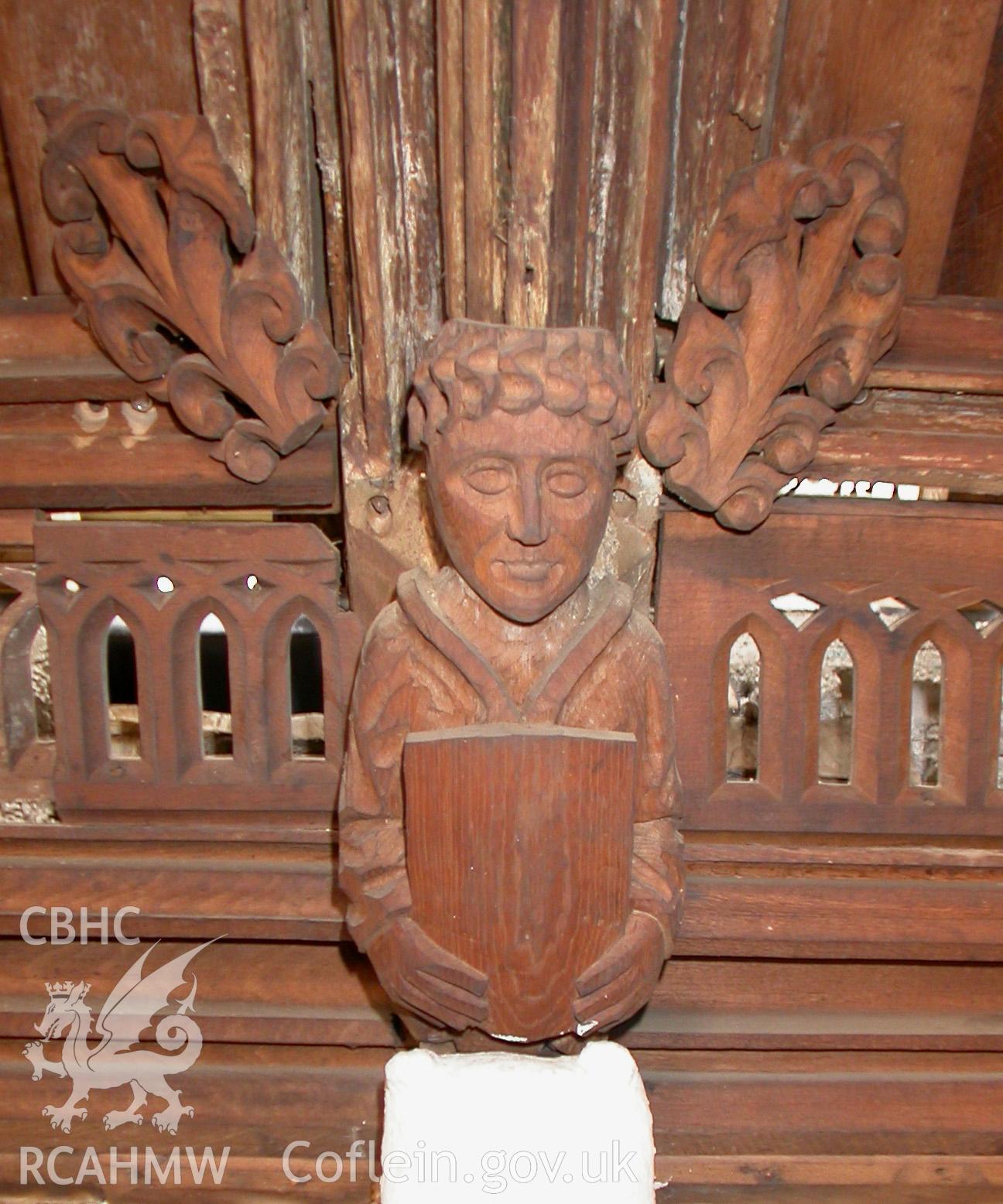 Carved wooden head between Trusses IV & V, South side.
