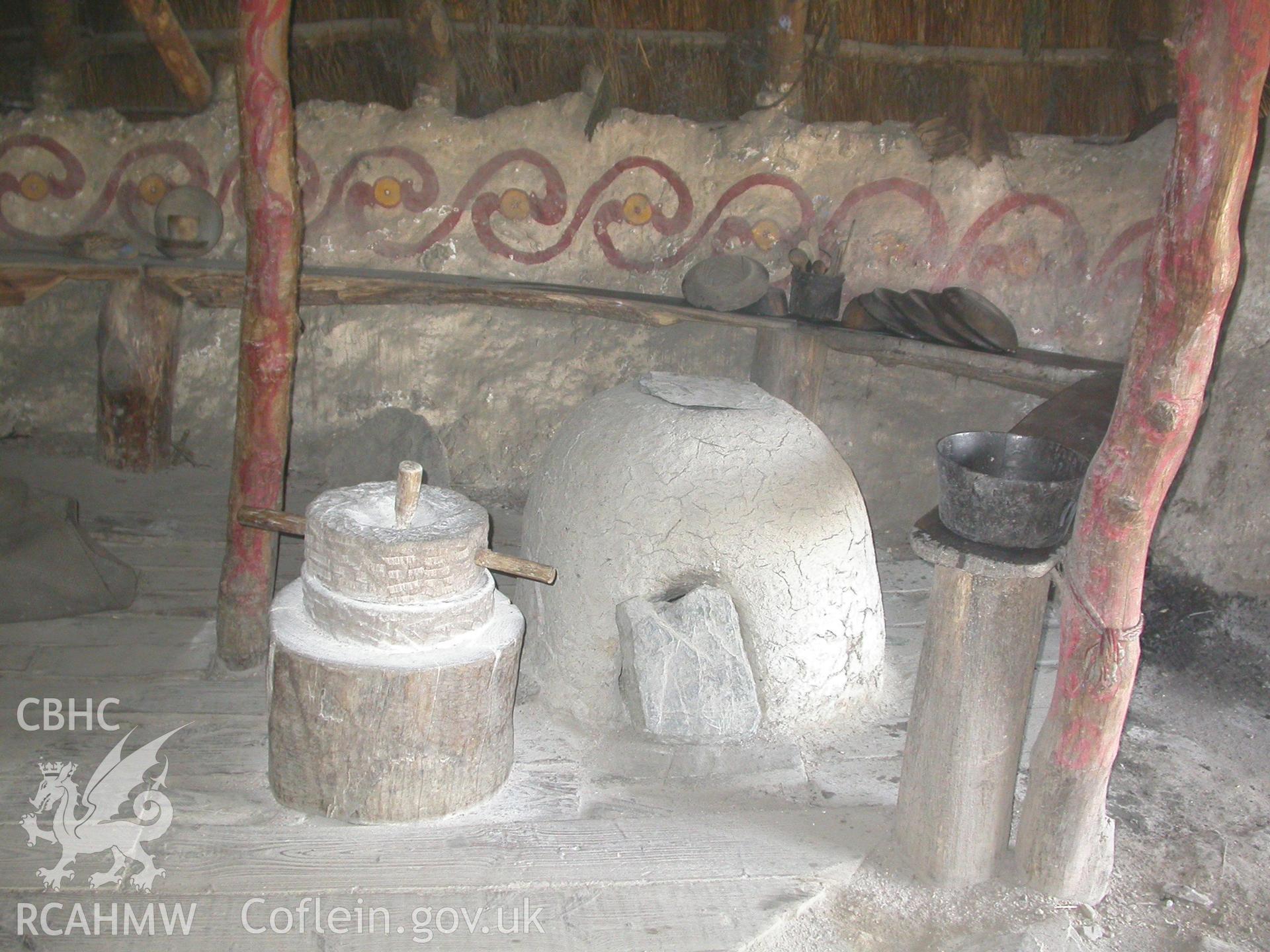 Corn-grinding quern and oven to the right of the entrance.