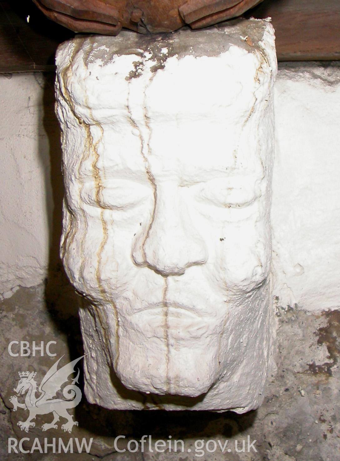 Carved stone head between Trusses VI & VII, north side.