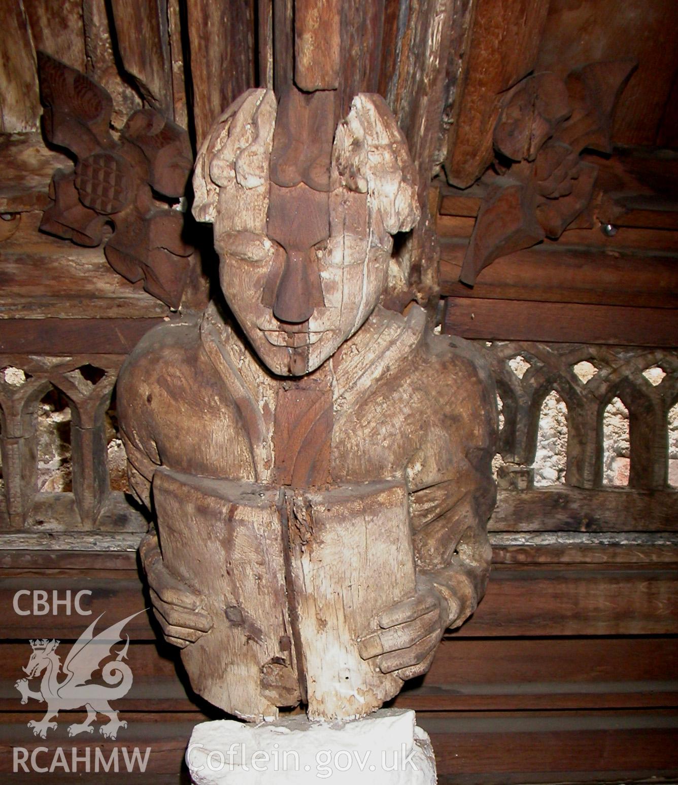 Carved wooden head between Trusses IV & V, North side.