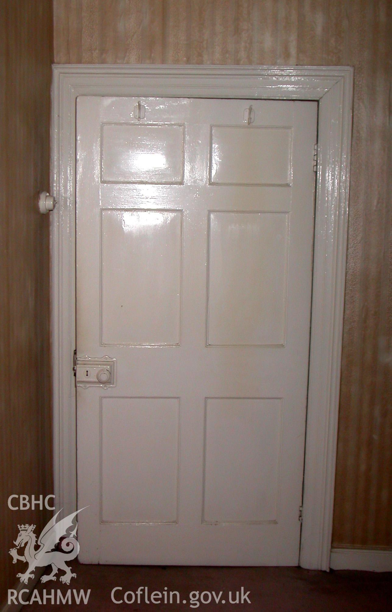 Six panelled door with moulded architrave in first floor room.