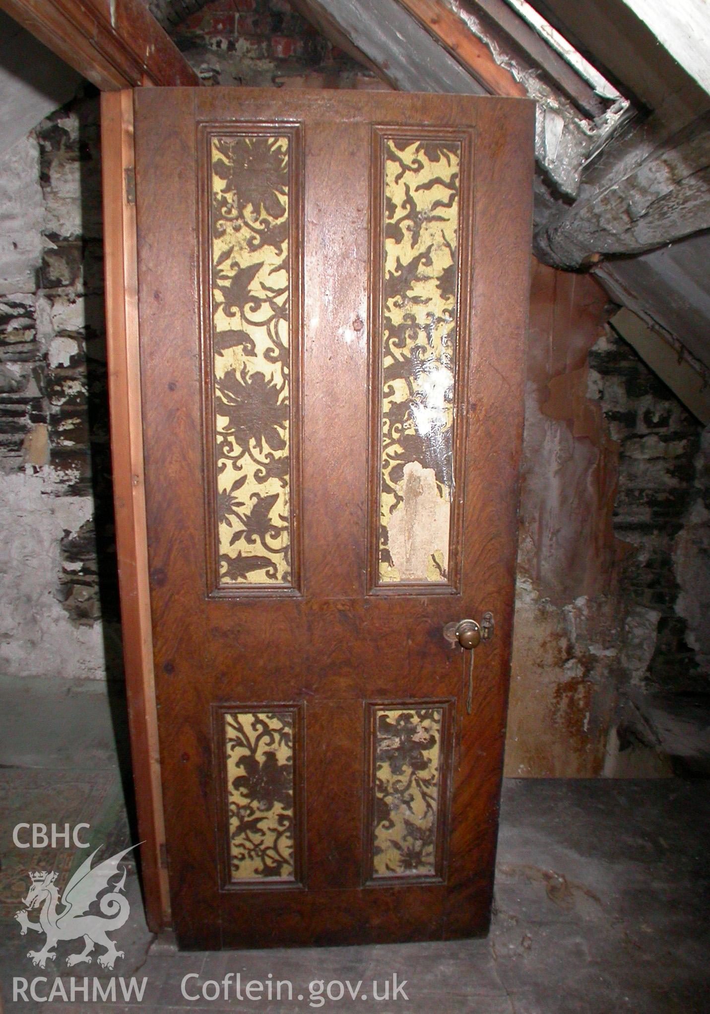 Four panelled door with inset panels surrounded by moulded beading, in attic.