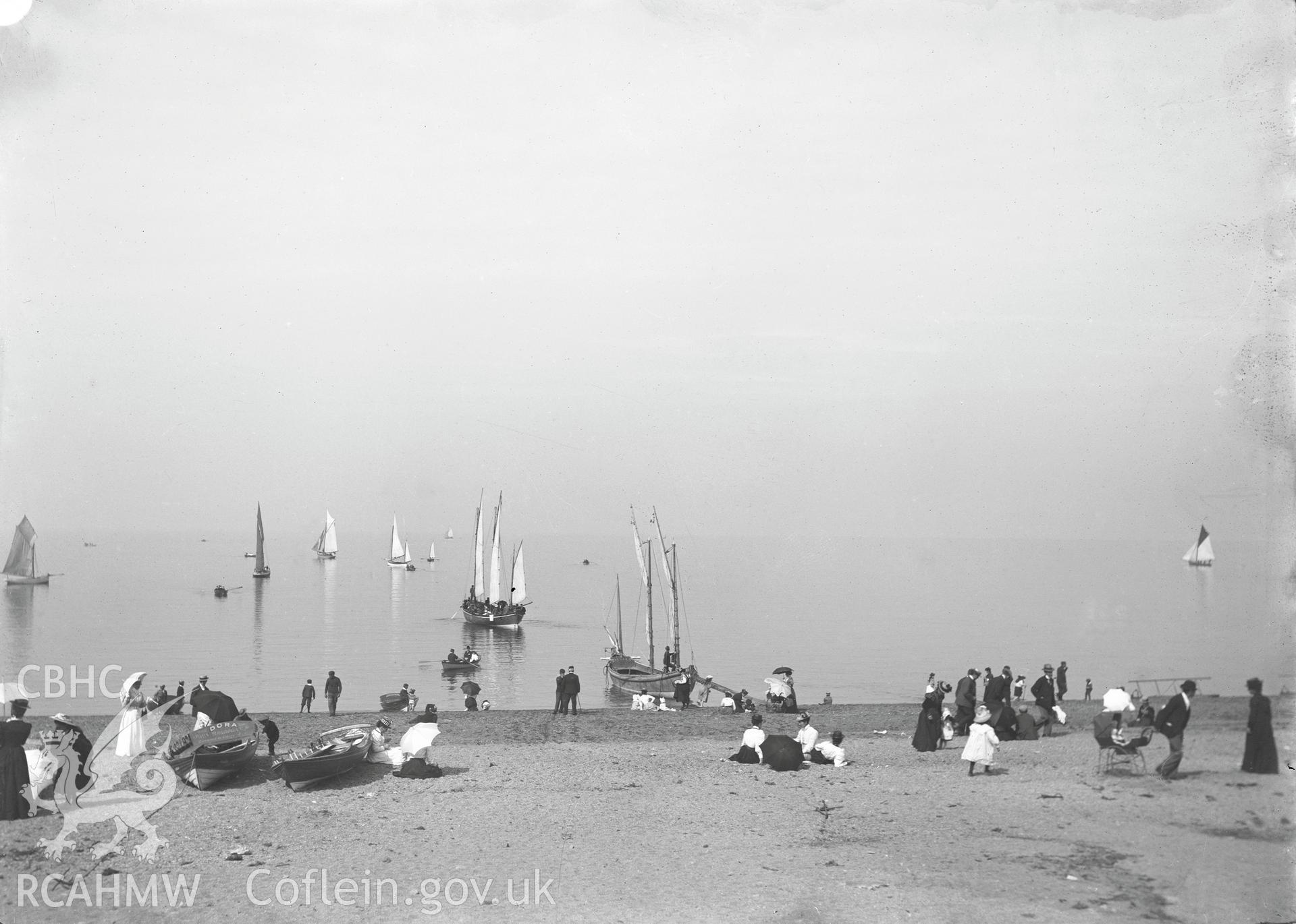 Black and white image dating from c.1910 showing a beach scene at Aberystwyth,  taken by Emile T. Evans.