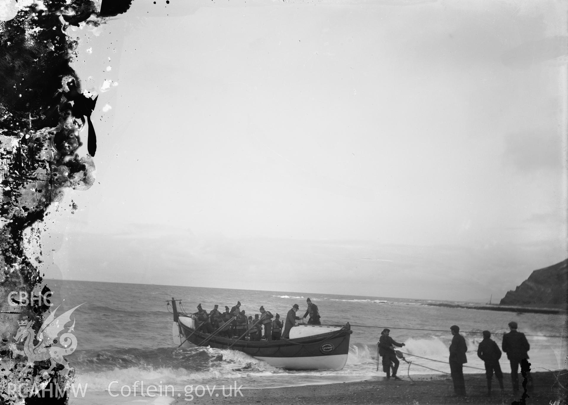 Black and white image dating from c.1910 showing the RNLI lifeboat and crew on the beach at Aberystwyth.