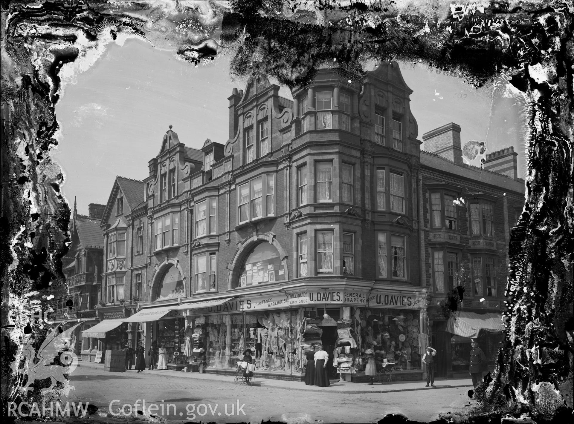 Black and white image dating from c.1910 showing view of U. Davies drapery and millinery which stood on the corner of Alexandra Road and Terrace Road, now occupied by Express Cafe.