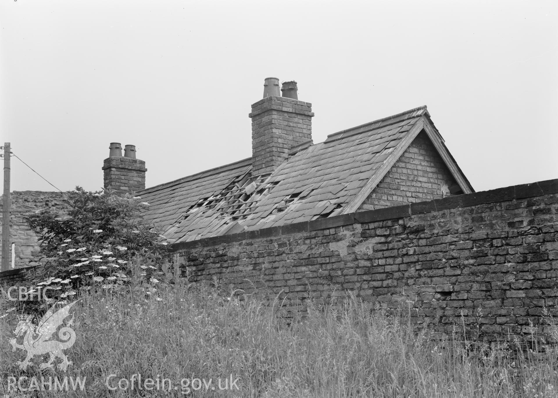 D.O.E photograph of Flint Gaol - damage to roof of cottage, from south.  In castle outer ward (since removed).
