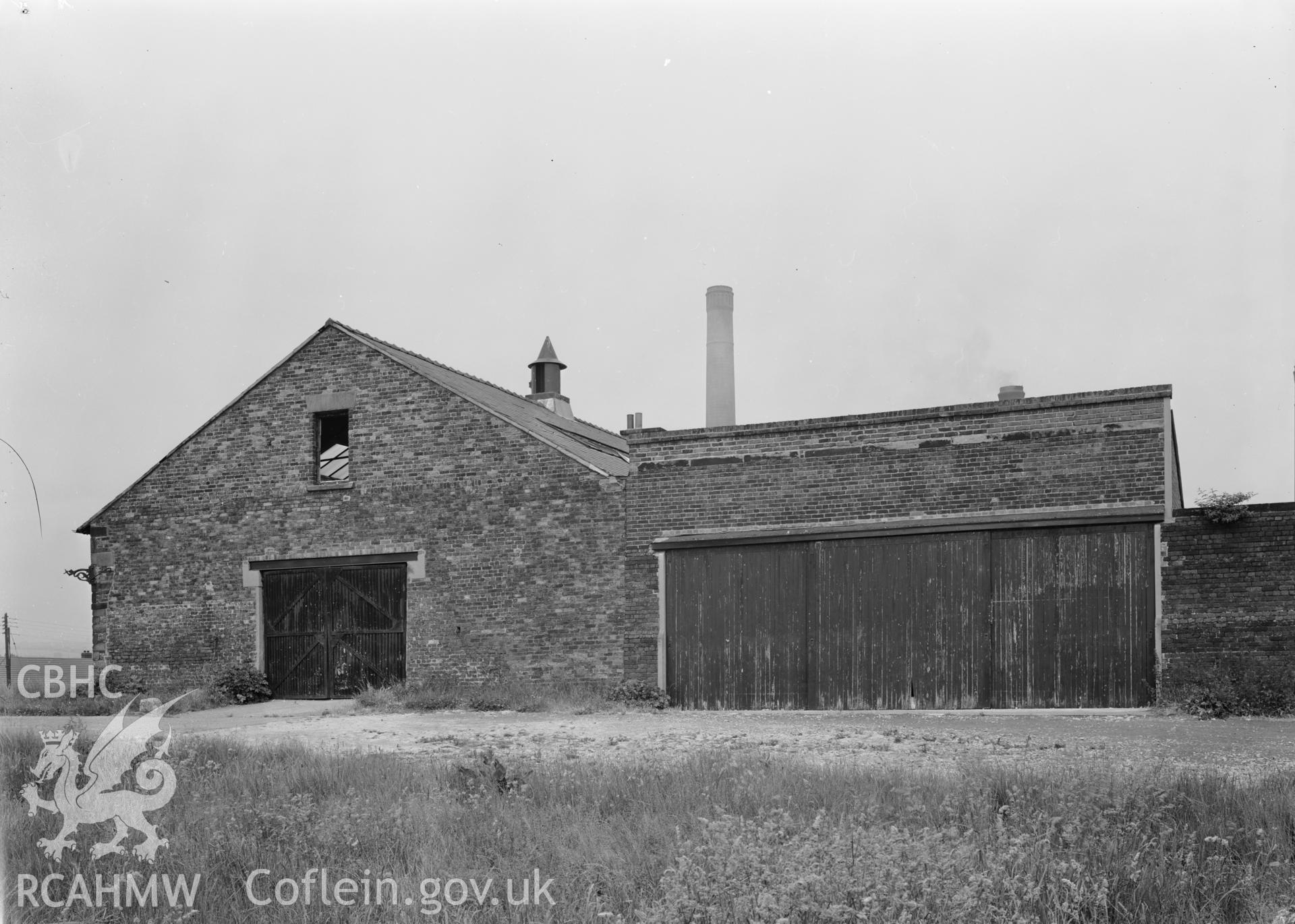 D.O.E photograph of Flint Gaol - south east elevation of drill hall and garages, from east. In castle outer ward (since removed).