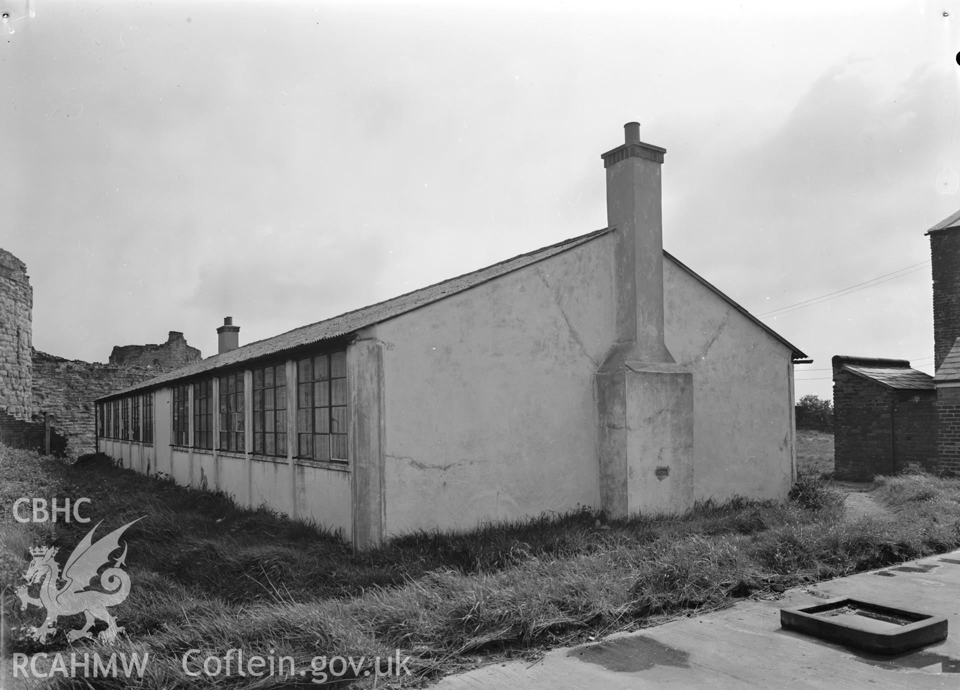 D.O.E photograph of Flint Gaol - army cadets hut from south west. In castle outer ward (since removed).