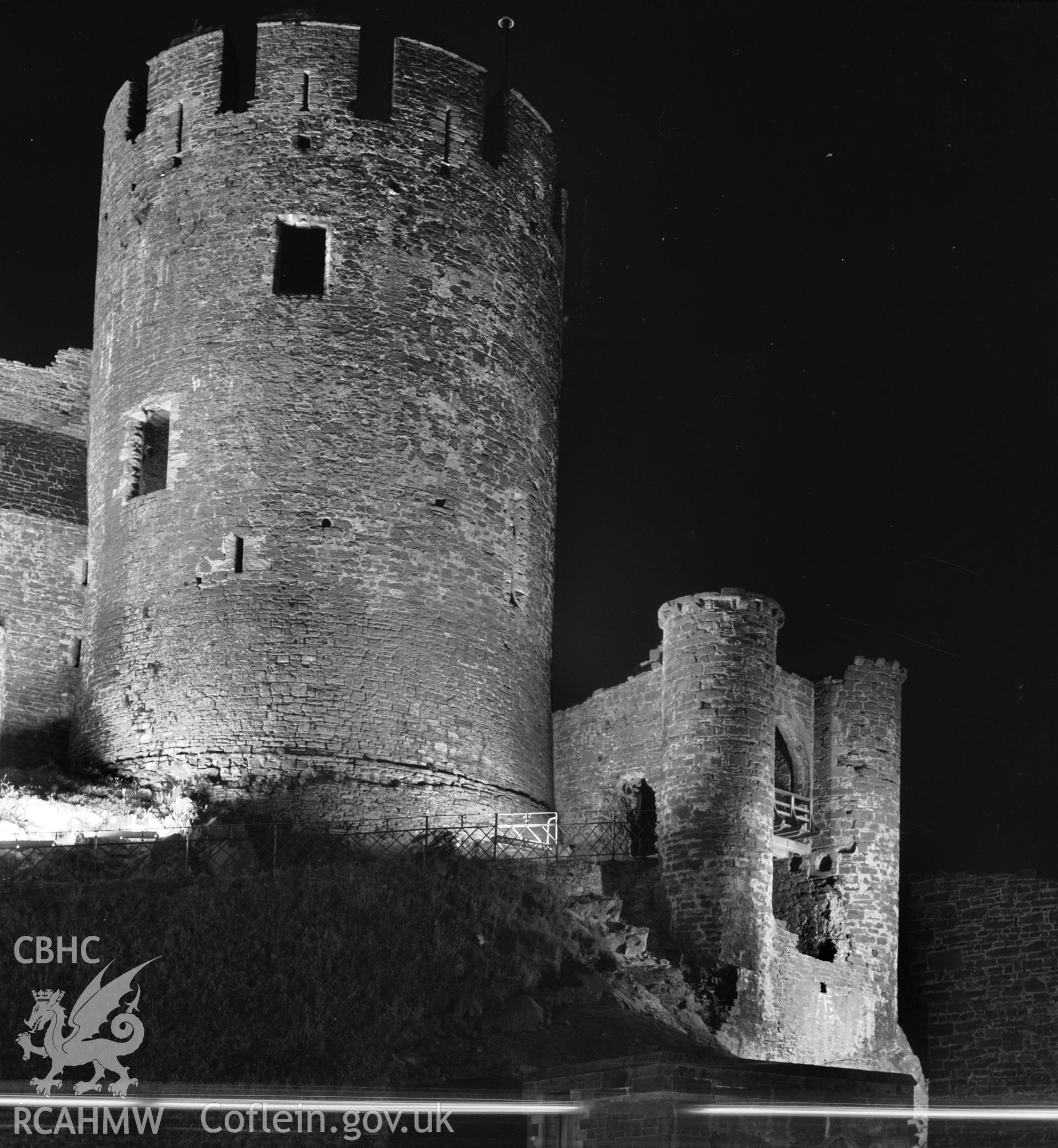 D.O.E photograph of Conwy Castle - floodlit from the North West, Tower and entrance to West Barbican.