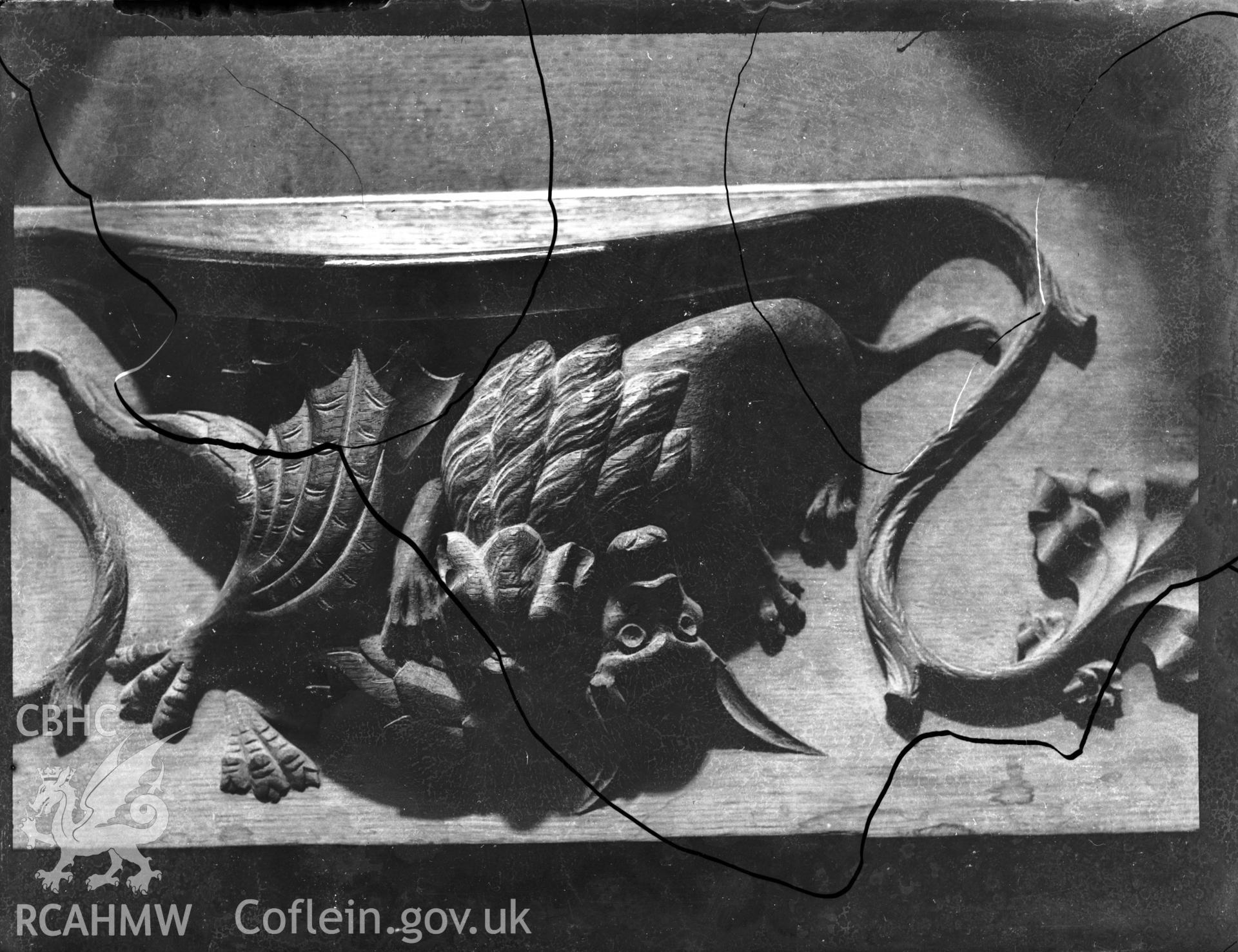 Black and white photo showing carved relief featuring a dragon, in St Davids Cathedral.