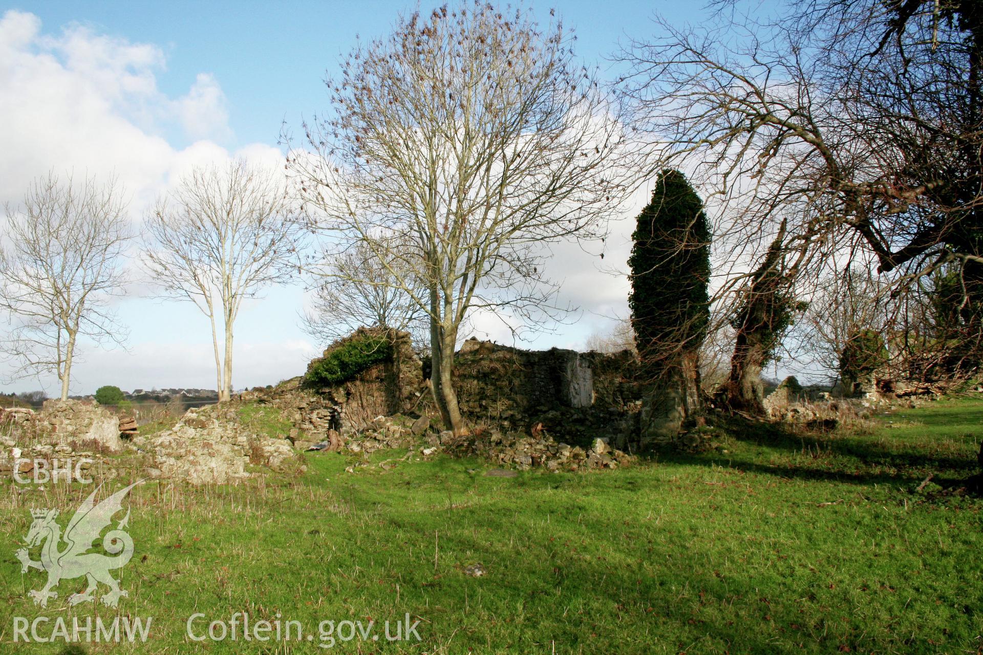 Haroldston House. Remains of the medieval hall from the south-west.  The ivy clad southern end of the hall is fronted by a wall of finely cut masonry.