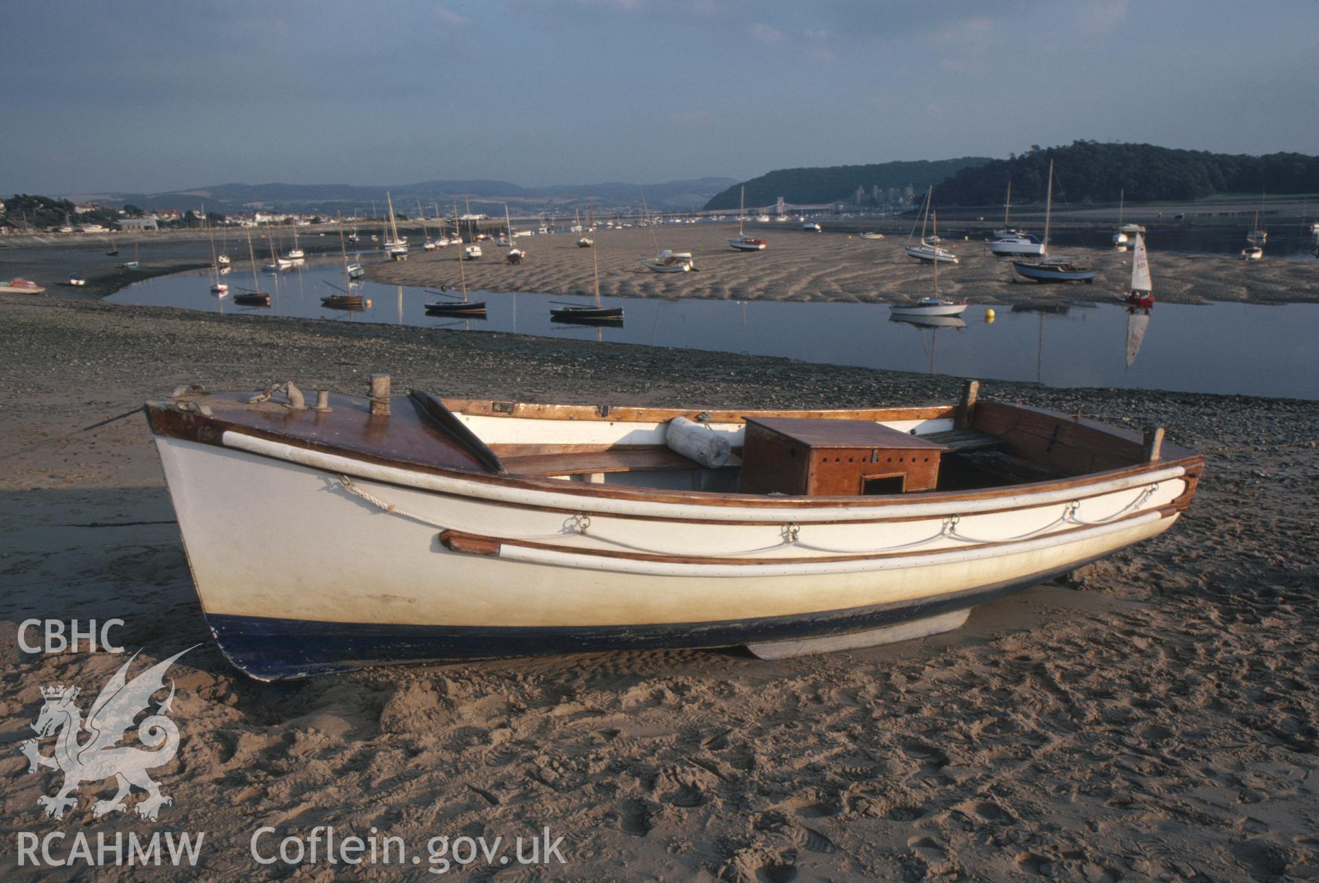 Colour photographic transparency showing view of Conwy beach with boats; collated by the former Central Office of Information.