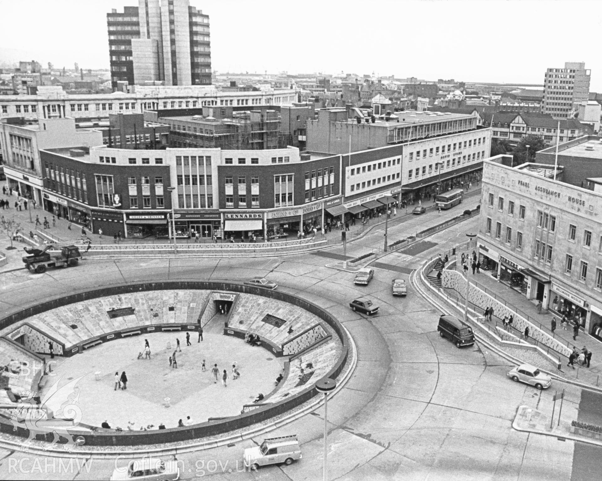 1 b/w print showing view of Swansea (including the large roundabout at the eastern end of the Kingsway which incorporated a pedestrian subway, the subway has now been filled in); collated by the former Central Office of Information.