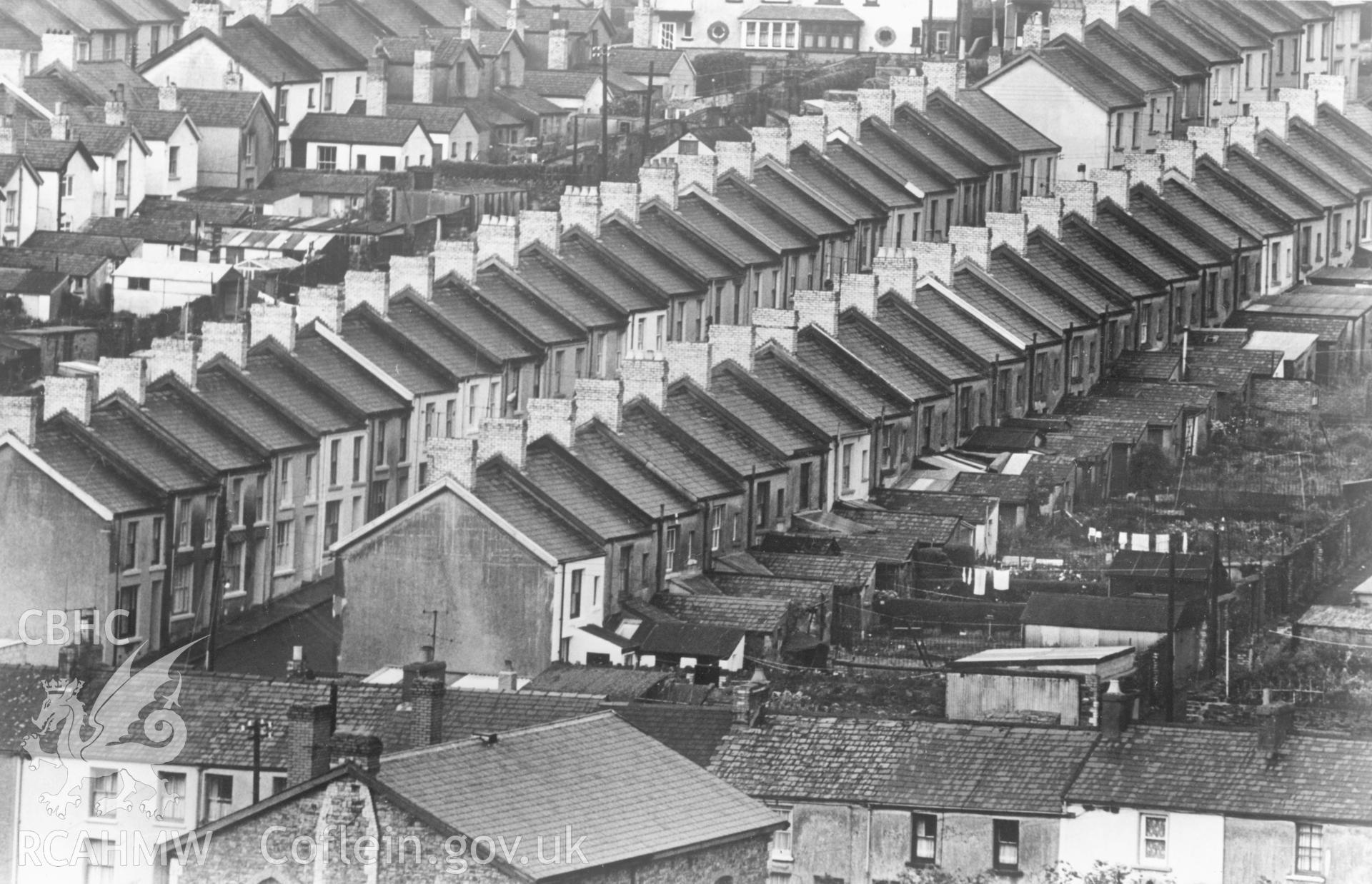 1 b/w print showing view of terraced housing on a hillside in Merthyr Tydfil; collated by the former Central Office of Information.