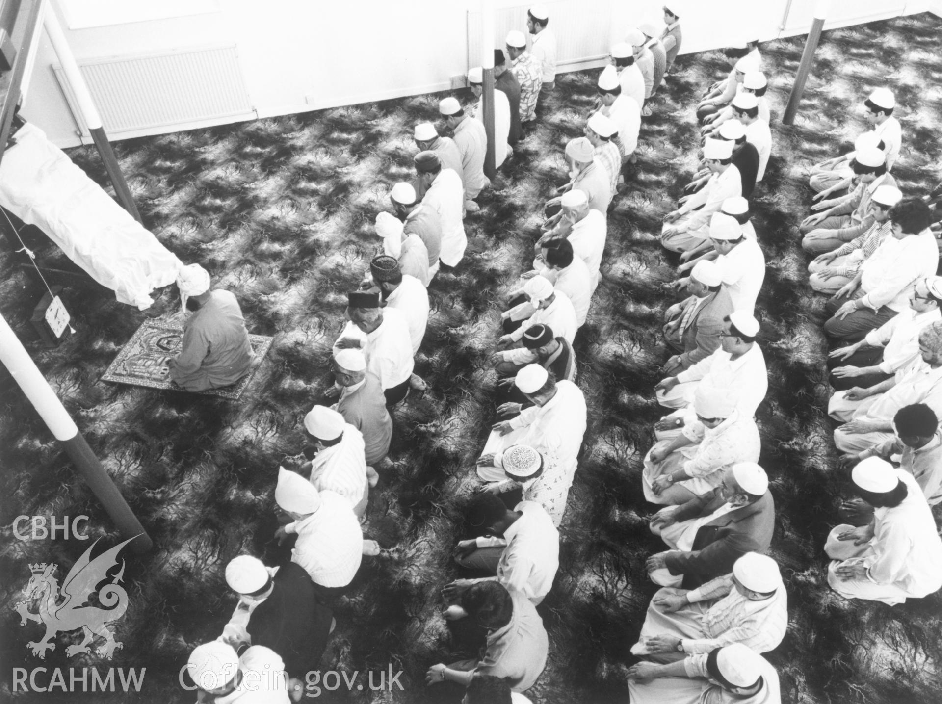 1 b/w print showing interior of Severn Road Mosque, Cardiff, with men and boys at prayer; collated by the former Central Office of Information.