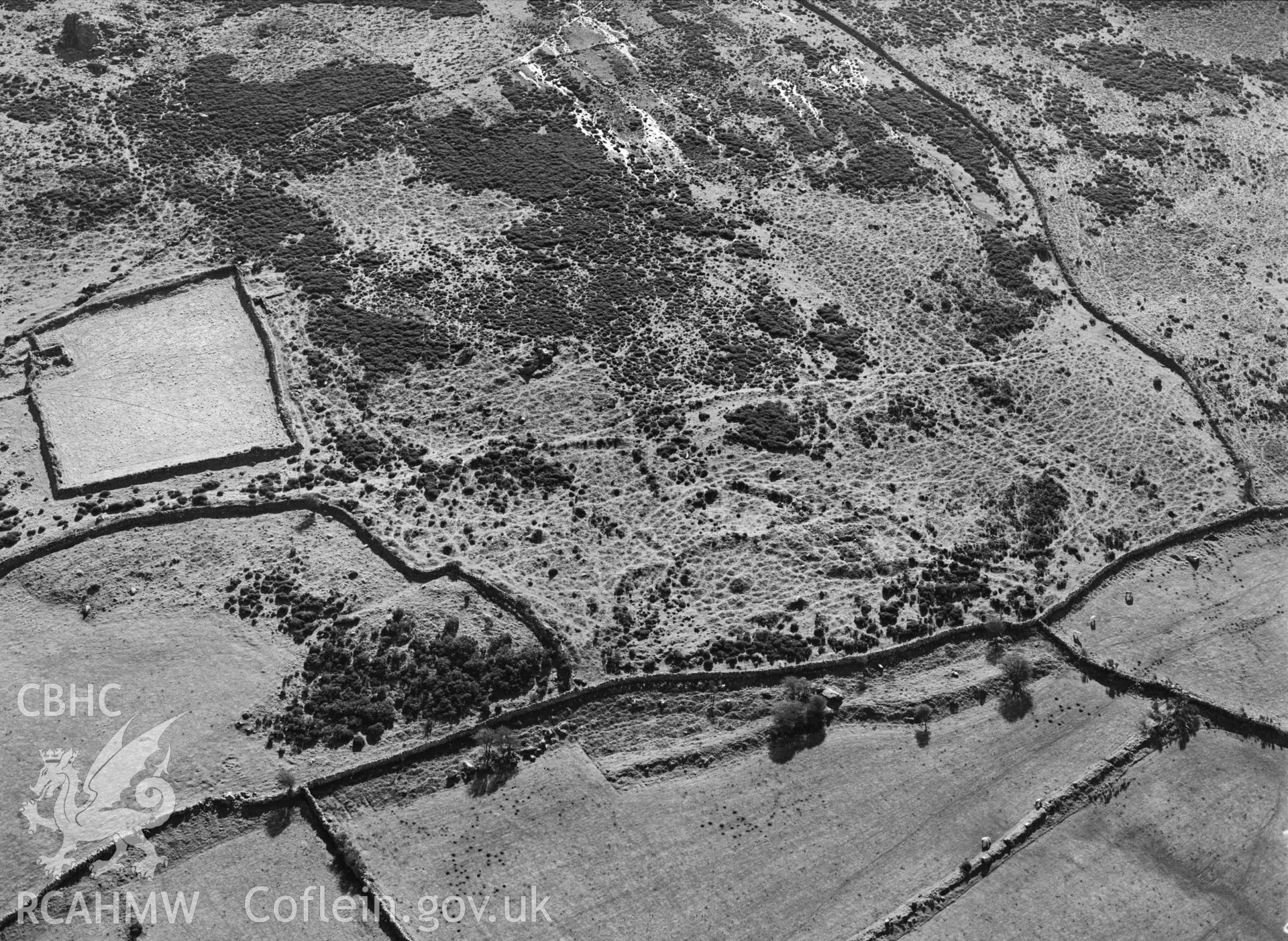 RCAHMW black and white oblique aerial photograph of possible settlement features  at Bryn Hyfryd, taken by C R Musson, 27/02/1996.