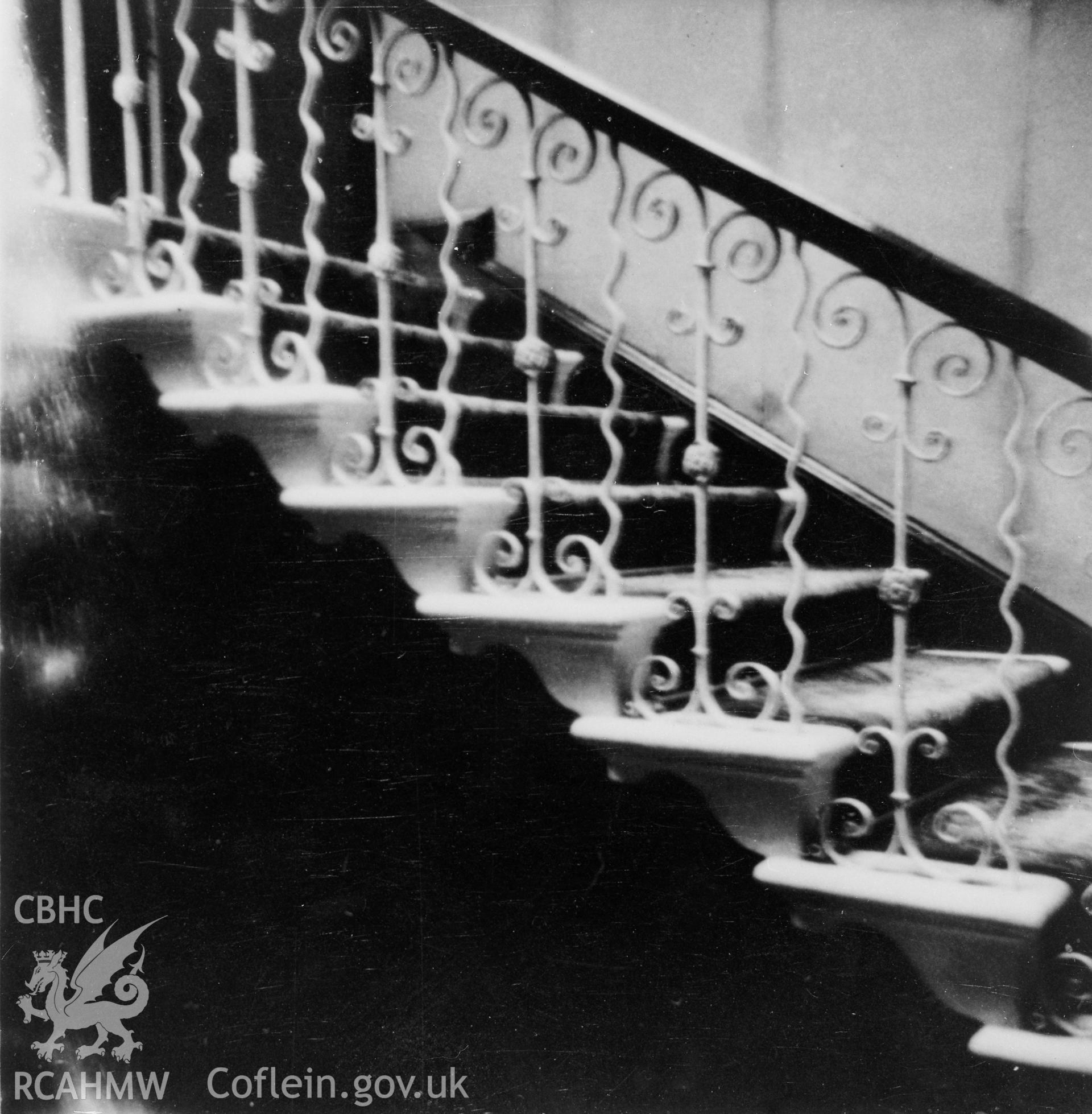 Black and white photographic print of an interior view of Llanaeron House, Ciliau Aeron, negative held.