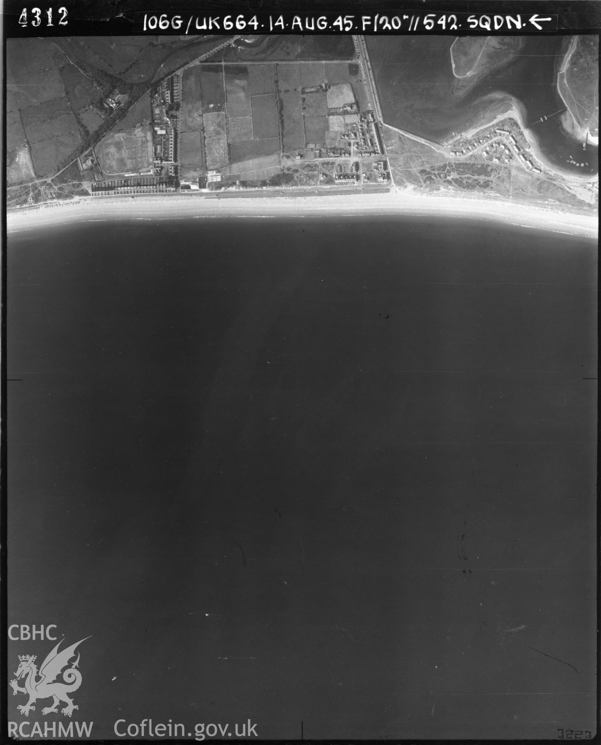 Black and white vertical aerial photograph taken by the RAF on 14/08/1945 showing the Pwllheli area and centred on SH37483356 at a scale of 1:10000. The centrepoint lies over the sea.