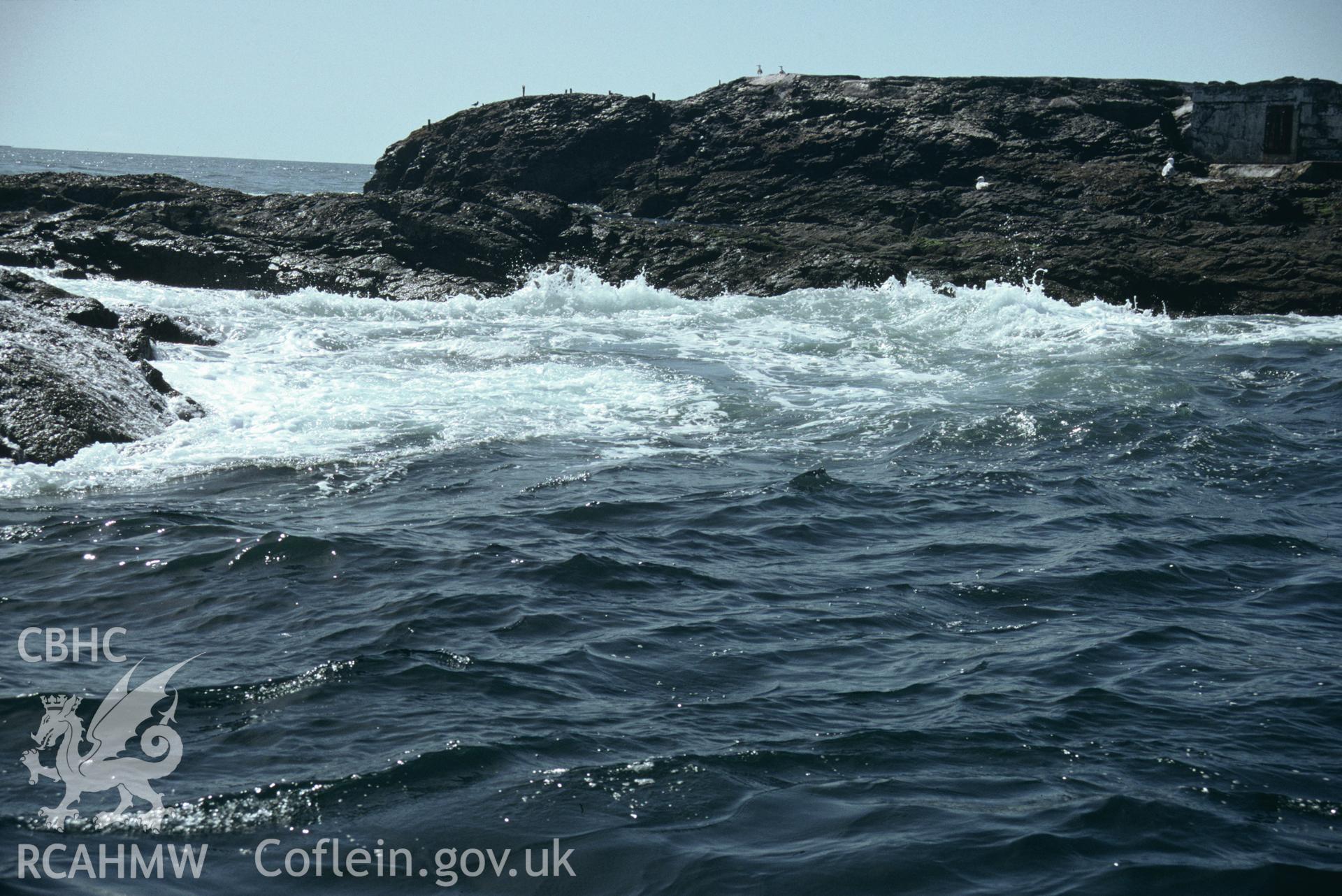 View of seawater surging through a gully between the rocky outcrops of the Smalls reef, one of a set of 22 colour slides from a survey of the Smalls designated shipwreck area, carried out by the Archaeological Diving Unit.