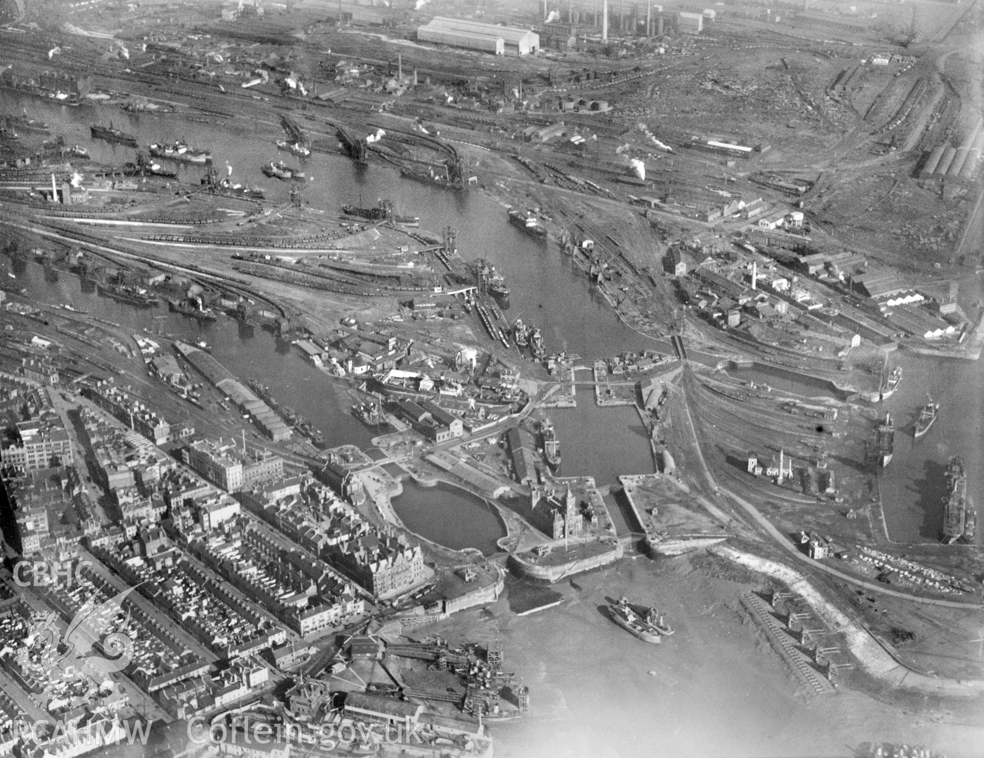 Black and white oblique aerial photograph showing Cardiff Docks, from Aerofilms album no W22 (Glamorgan Cardiff), taken by Aerofilms Ltd and dated 1925.
