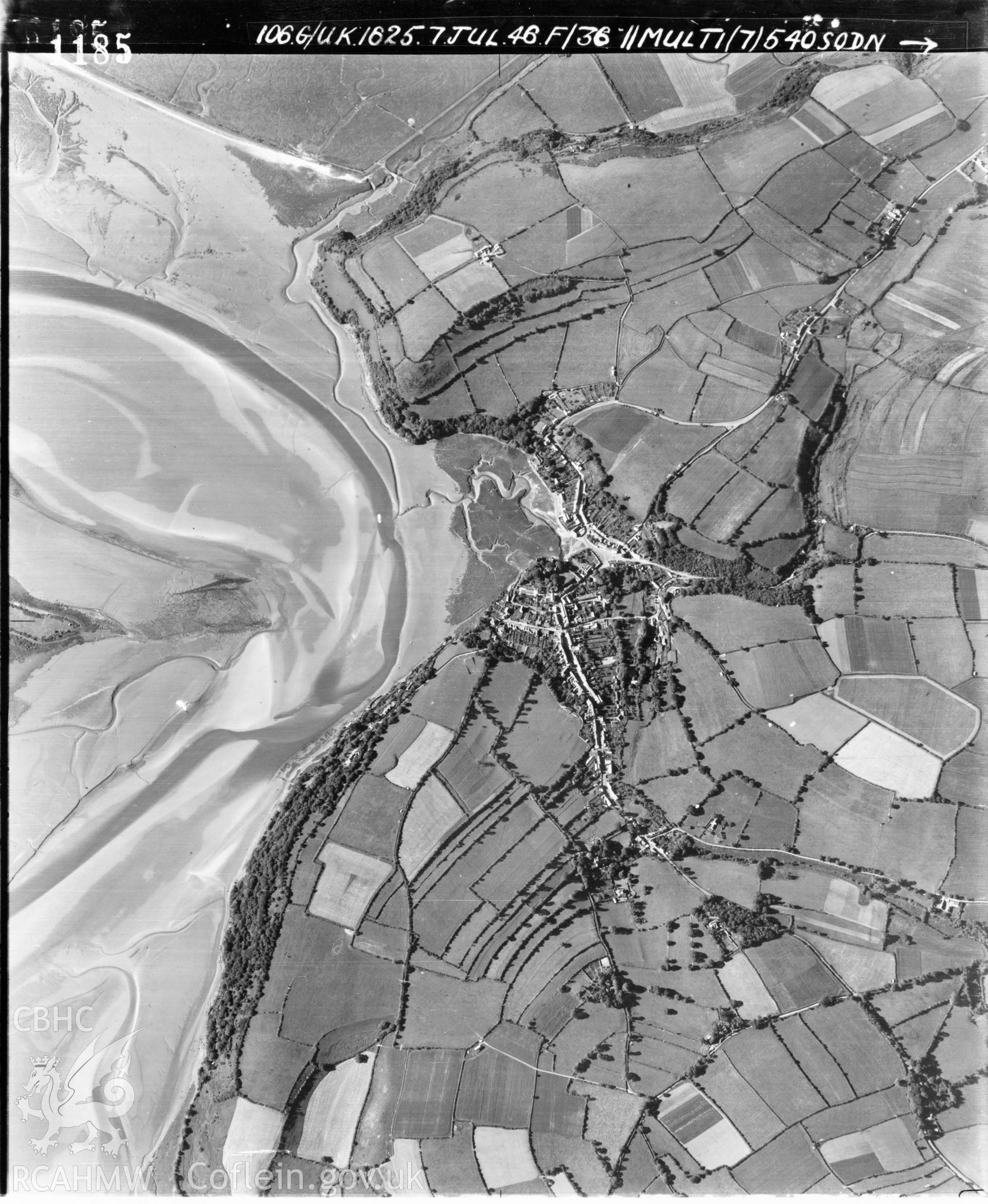 Black and white vertical aerial photograph taken by the RAF on 07/07/1946 centred on SN30381087 at a scale of 1:10000. The photograph includes part of Laugharne Township community in Carmarthenshire.