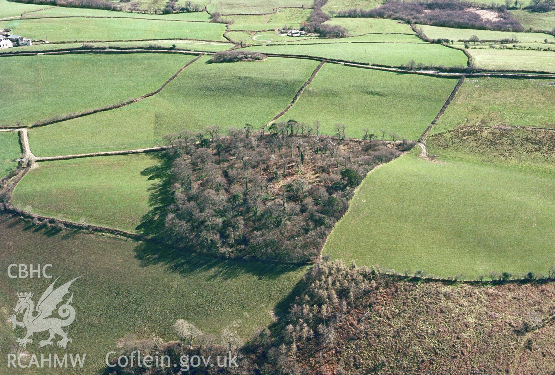 RCAHMW colour oblique aerial photograph of Pen y Garn enclosure. Taken by C R Musson on 29/03/1995