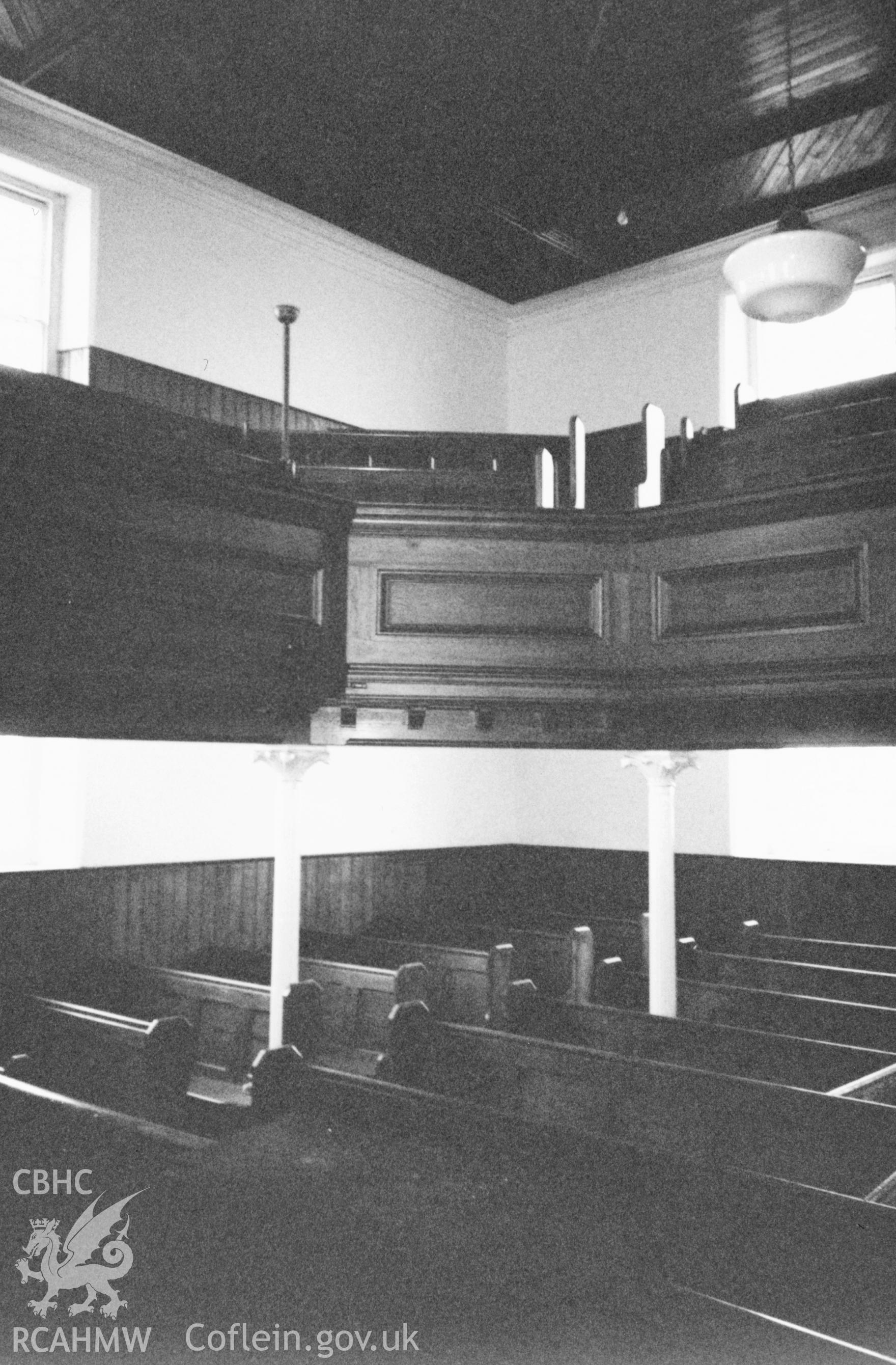 Digital copy of a black and white photograph showing an interior view of Libanus Baptist Chapel, Llansadwrn, taken by Robert Scourfield, 1996.