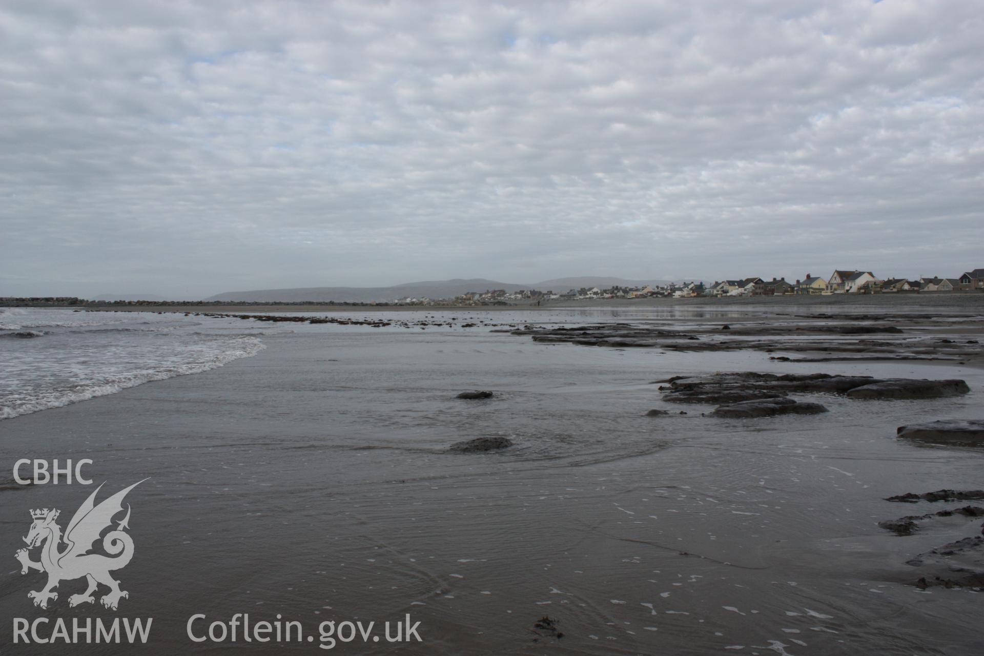 Borth submerged forest (between RNLI lifeboat station and upper Borth), looking northeast towards High Street and Ynyslas. Showing extent of peat exposures at low tide and temporary causeway leading to artificial reef (centre left-centre).