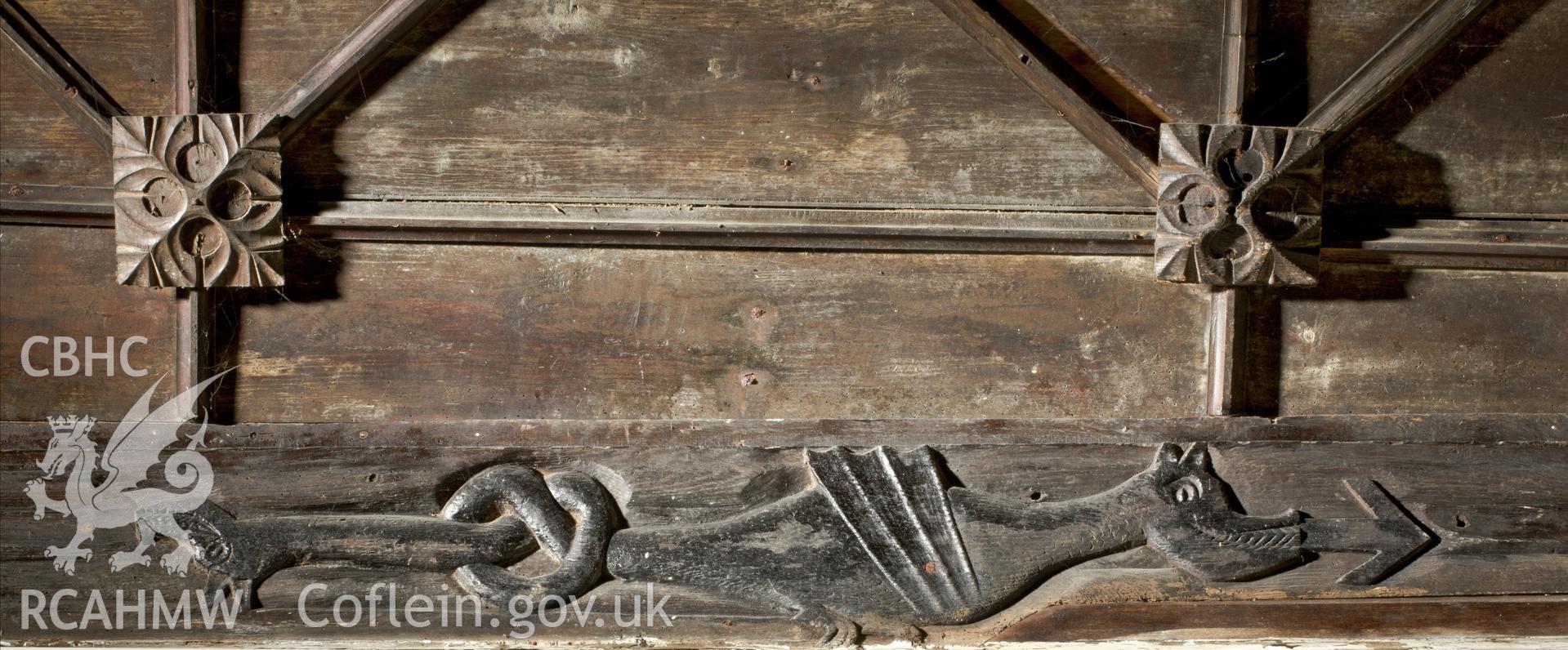 Carved serpent on wall plate to north of altar.