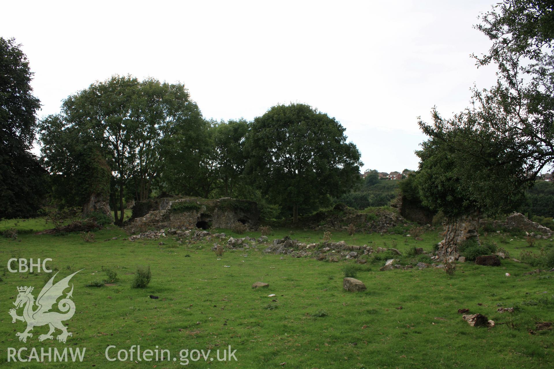 Looking north-west, this photograph shows the remains of the early hall, with later southern extensions and inner courtyard wall to wards the front of the image.