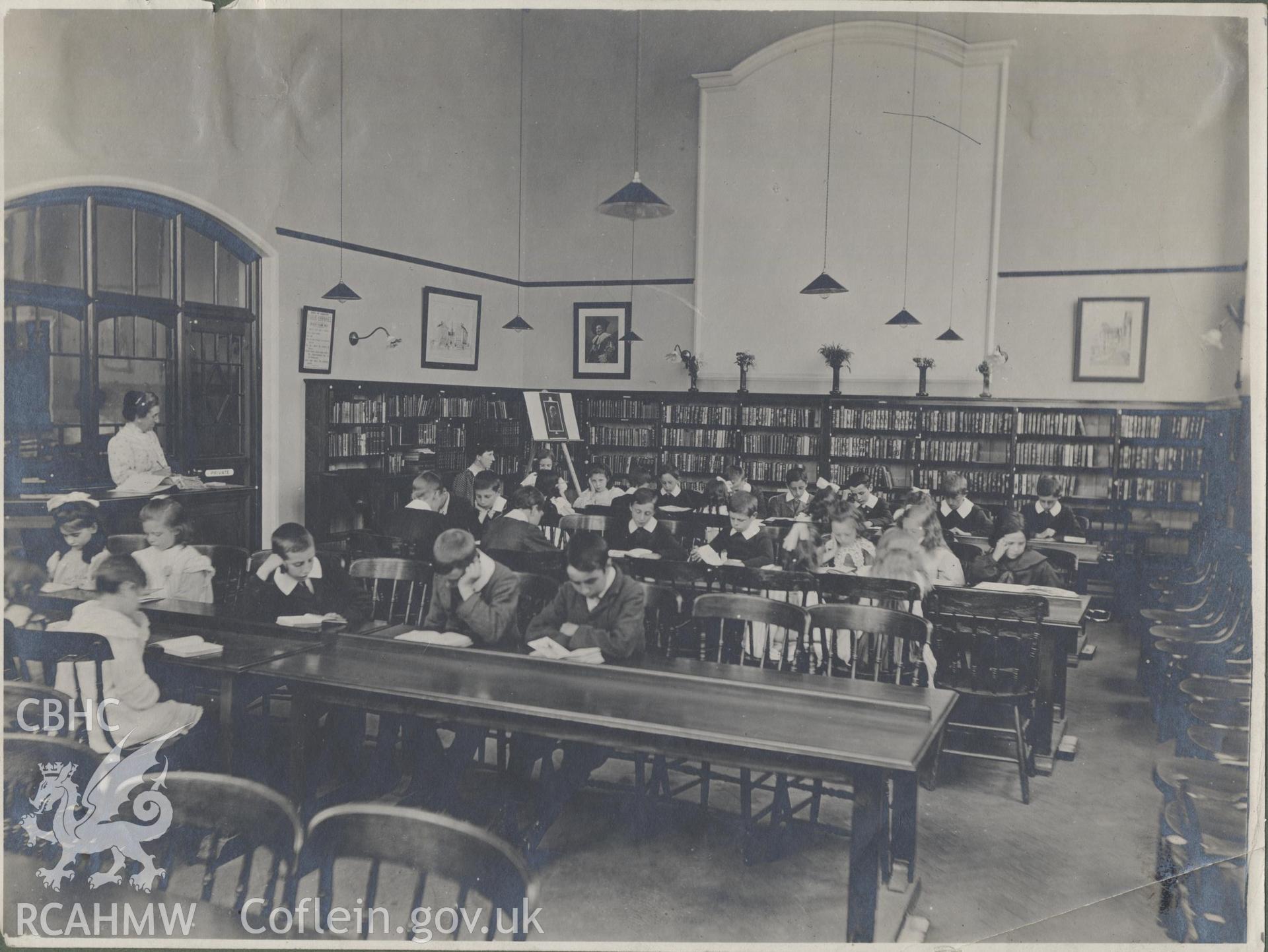 Black and white photograph showing school children working in Cathays Public Library, Cardiff.