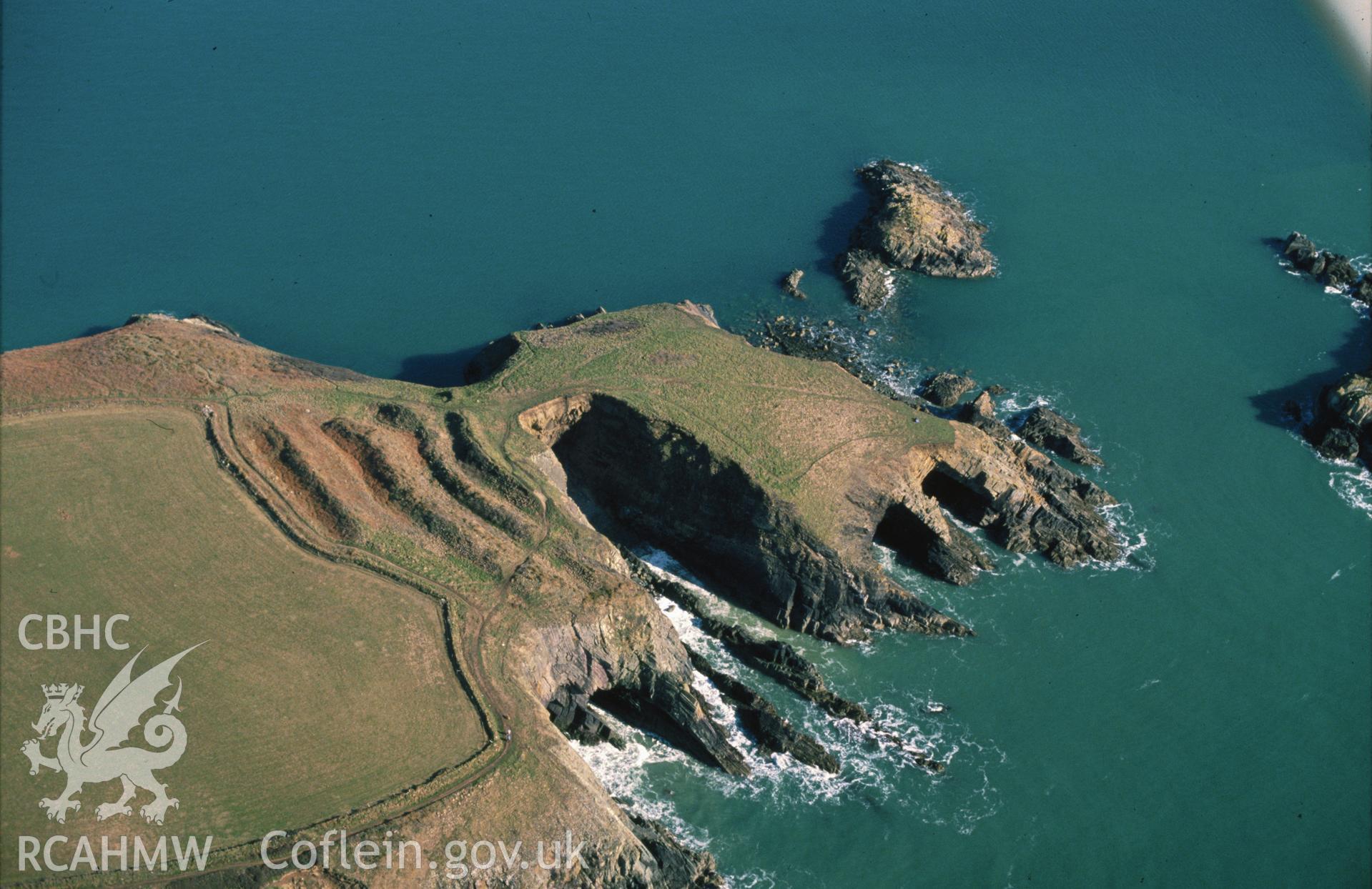 Slide of RCAHMW colour oblique aerial photograph of Caerfai Promontory Fort south of St Davids, taken by C.R. Musson, 24/3/1991.