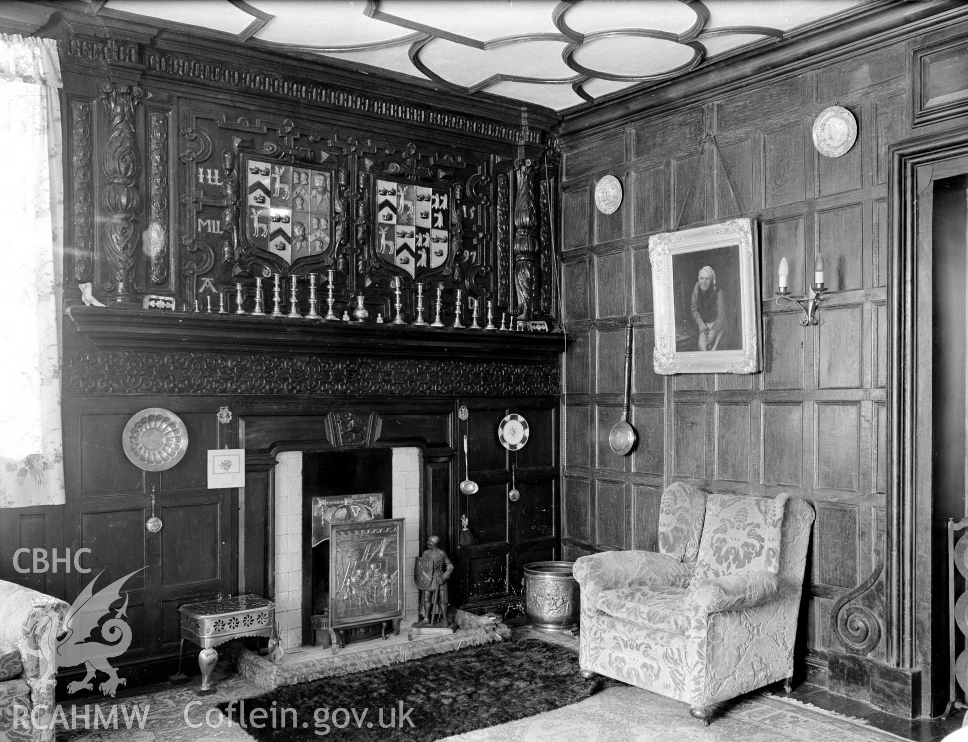 Carved Fireplace. Tudor wood panelled walls. Above the fire place are two different coat of arms.
