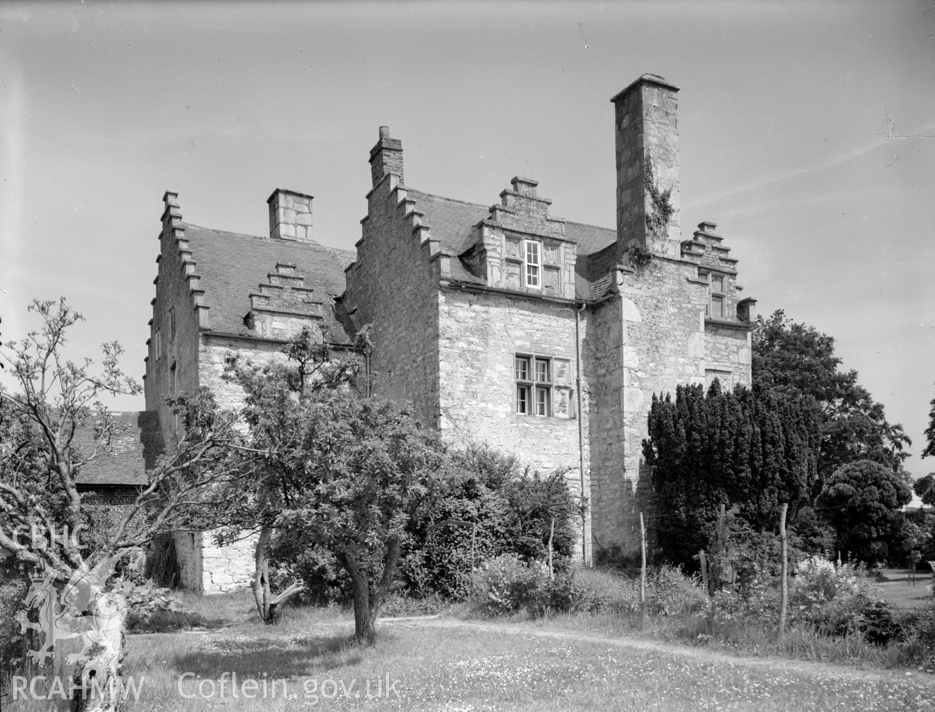 Back of farmhouse. View of back chimney and its outline down the outside of the wall.