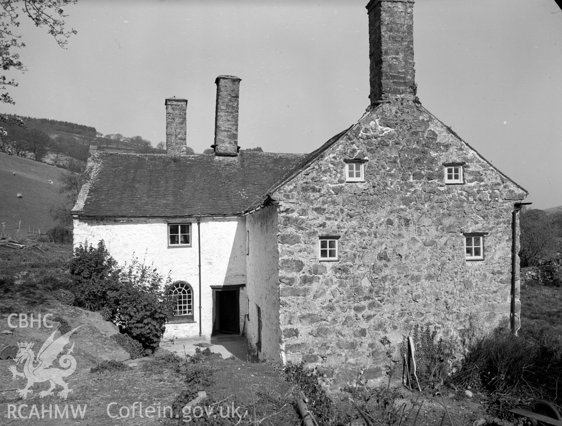 A view of Plas Llan's leaning chimney. Also visible is a an arched window next to the south door.