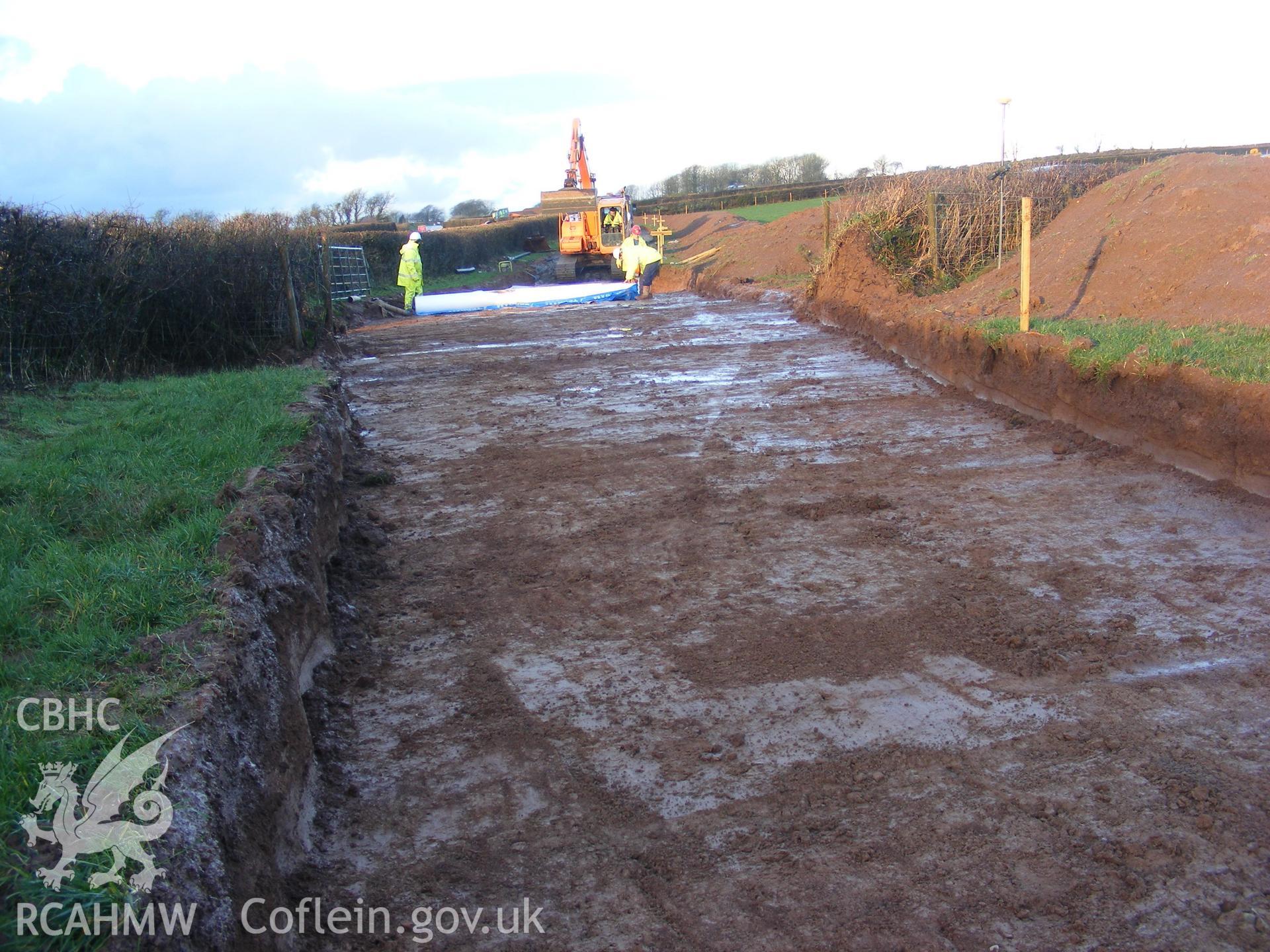 View showing laying stone at Track D, taken at archaeological watching brief at Princes Gate Spring Water, produced by Headland Archaeology (UK) Ltd., 2014.