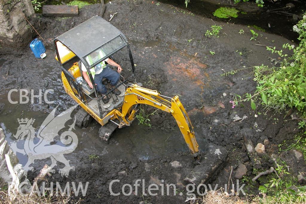 Digital image relating to Melingriffith Water Pump: Mini excavator collecting silt and debris from the head-race.