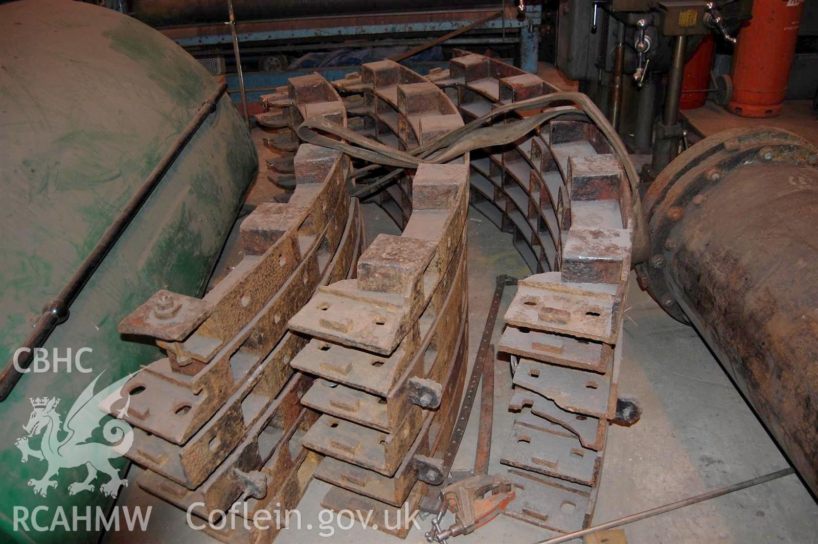 Digital image relating to Melingriffith Water Pump: Wheel rim sections stacked ready for cleaning.