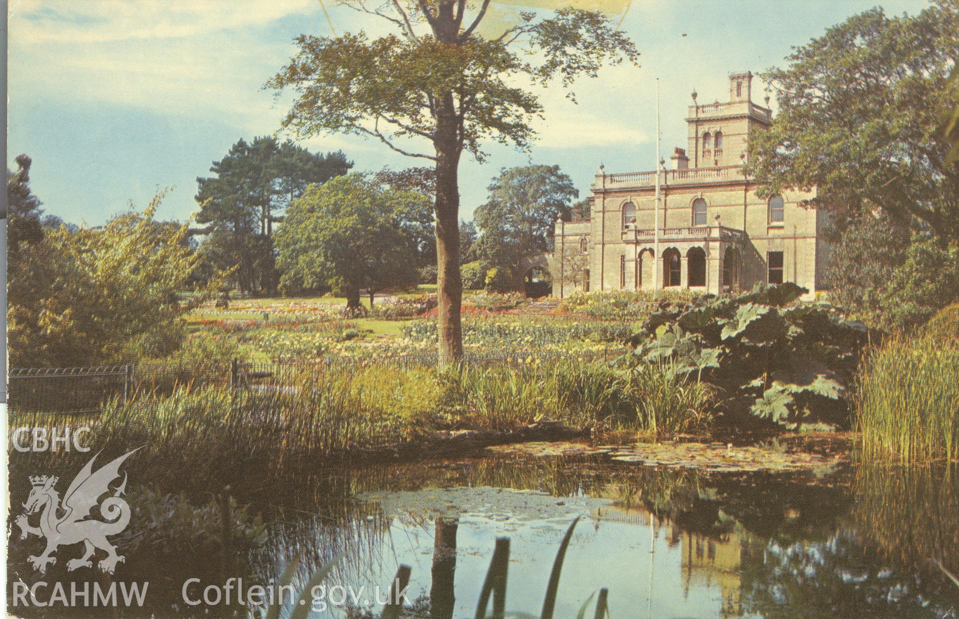 Digitised postcard image of lily pond, gunnera, and flower garden at Parc Howard garden, Llanelli. Produced by Parks and Gardens Data Services, from an original item in the Peter Davis Collection at Parks and Gardens UK. We hold only web-resolution images of this collection, suitable for viewing on screen and for research purposes only. We do not hold the original images, or publication quality scans.