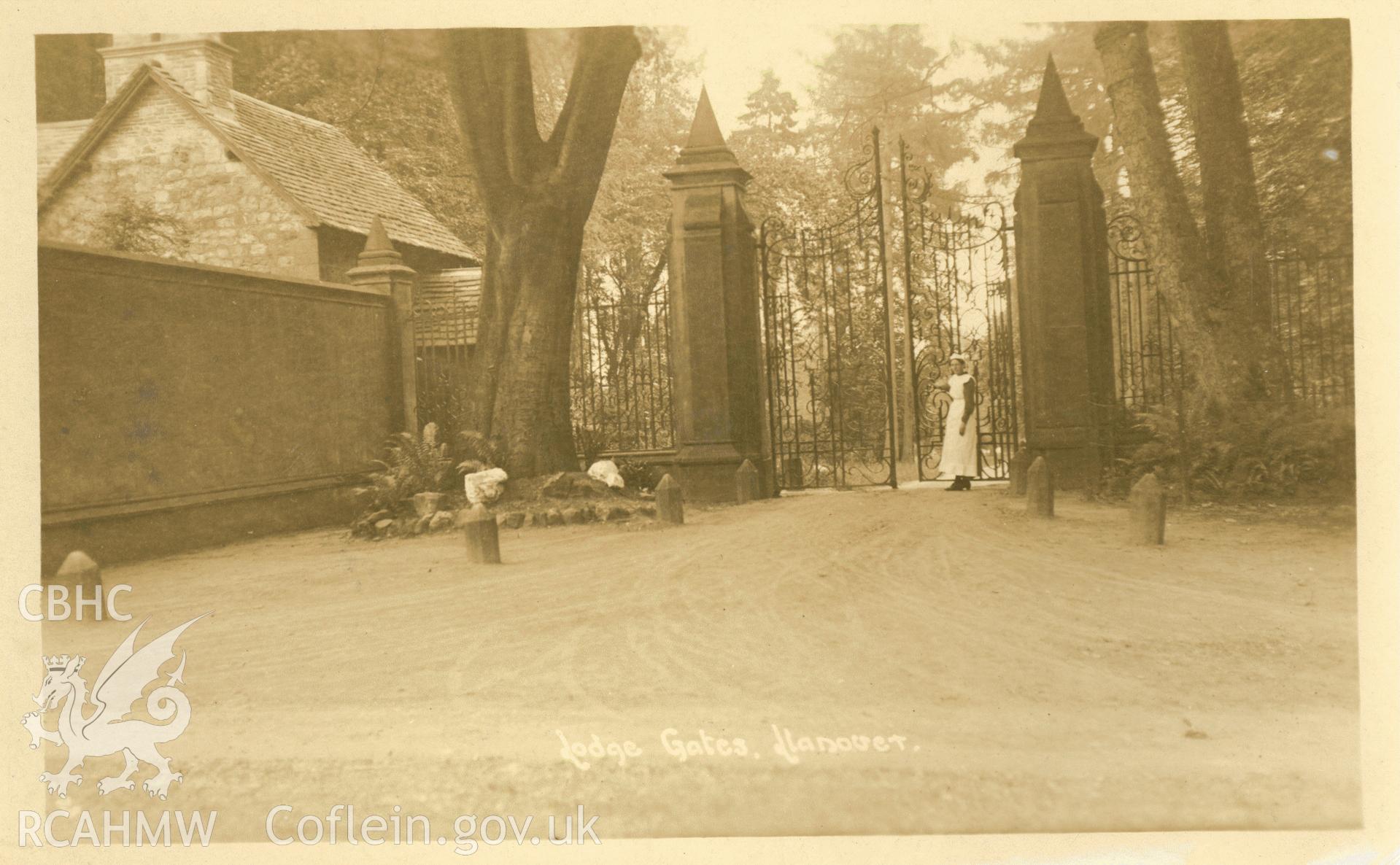 Digitised postcard image of Lodge gates, Llanover, with figure. Produced by Parks and Gardens Data Services, from an original item in the Peter Davis Collection at Parks and Gardens UK. We hold only web-resolution images of this collection, suitable for viewing on screen and for research purposes only. We do not hold the original images, or publication quality scans.