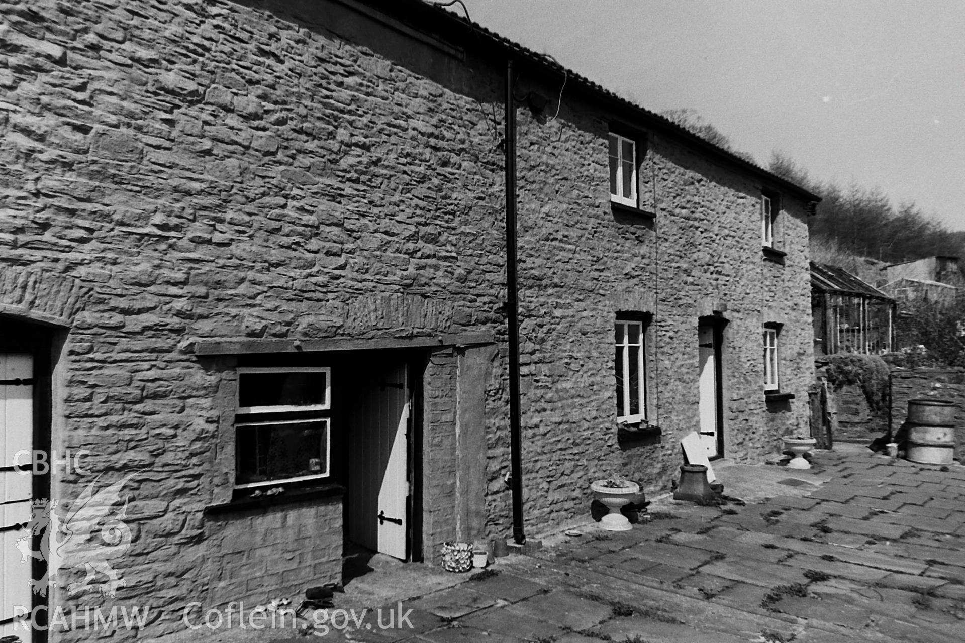 Black and white photo showing exterior view of Ffynnon Dwym, taken by Paul R. Davis, 1984.