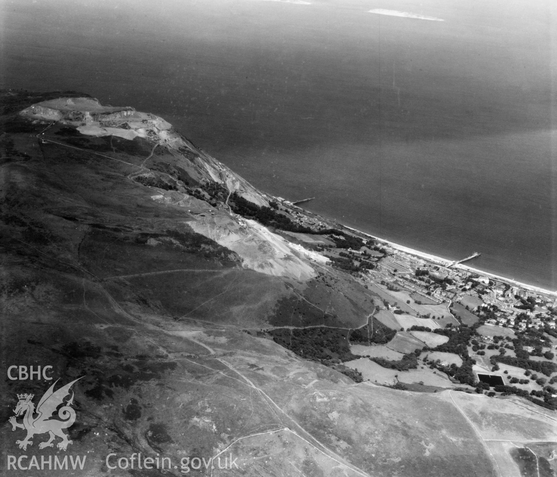 View of Penmaenmawr and Welsh Granite Co. Ltd. Quarries at Penmaenmawr. Oblique aerial photograph, 5?" cut roll film.